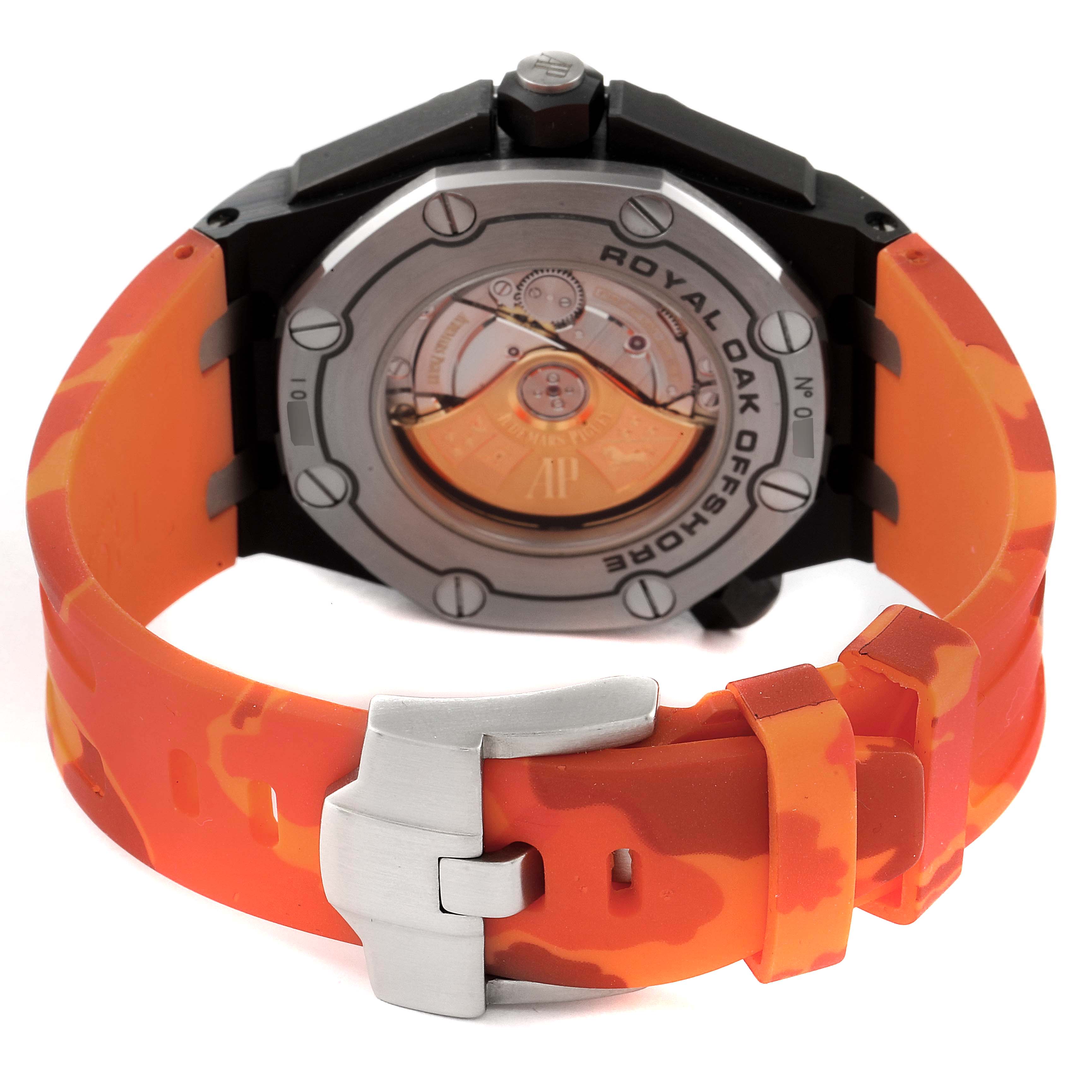 The image shows the back of an Audemars Piguet Royal Oak Offshore 15707CE.OO.A002CA.01 Men's Ceramic Black Dial 15707CE.OO.A002CA.01 Men's Ceramic Black Dial watch, focusing on the case back, movement, and orange rubber strap.