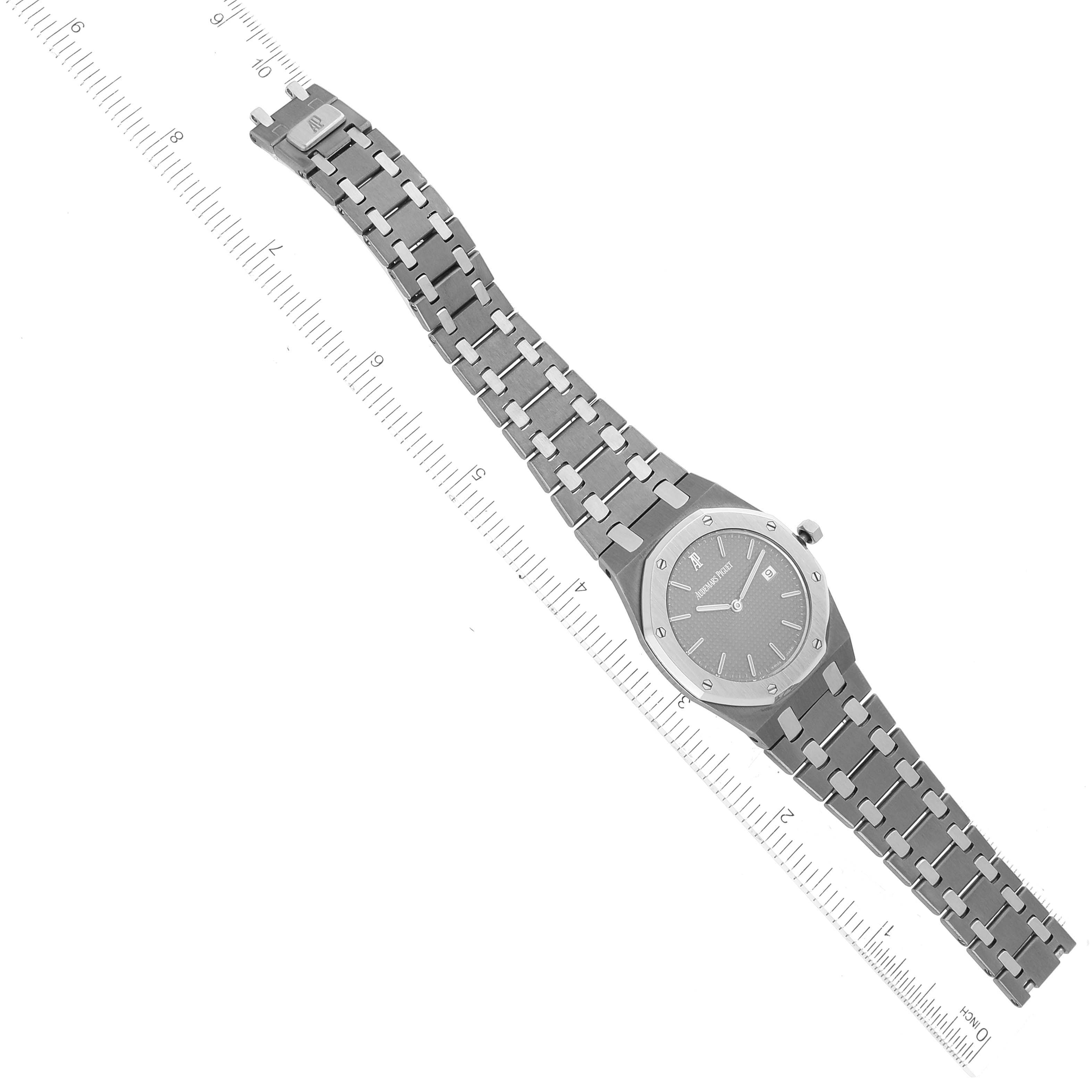 This Royal Oak model by Audemars Piguet is shown from a top-down angle and includes the watch face, bezel, and full bracelet.