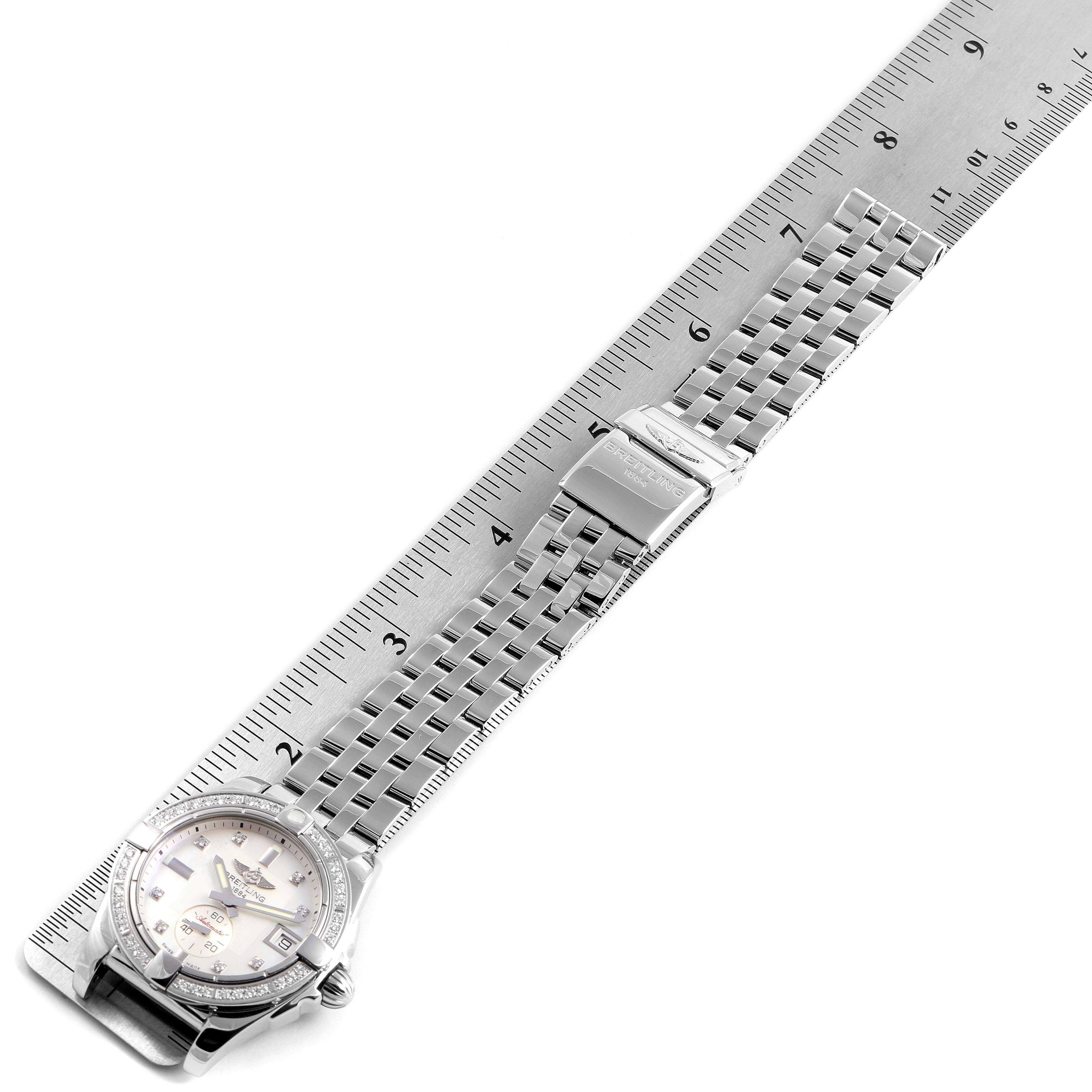 The Galactic 36 Mother of Pearl Diamond Steel Ladies Watch A37330 by Breitling A37330 Women's Stainless Steel Mother of Pearl Dial A37330 Women's Stainless Steel Mother of Pearl Dial is shown at an angle with its band extended along a ruler.