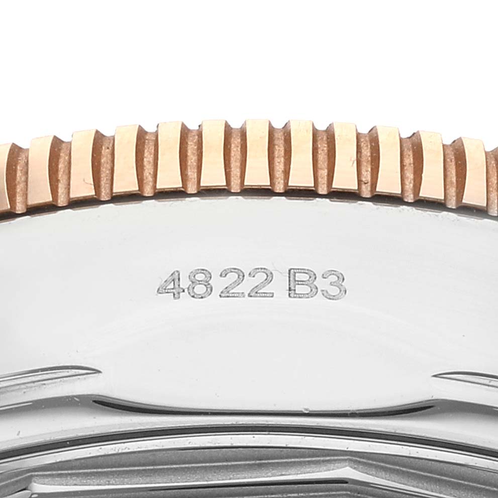 This close-up image shows the scalloped bezel and etched serial number of the Breitling Superocean UB2010 Men's Stainless Steel Black Dial UB2010 Men's Stainless Steel Black Dial watch.