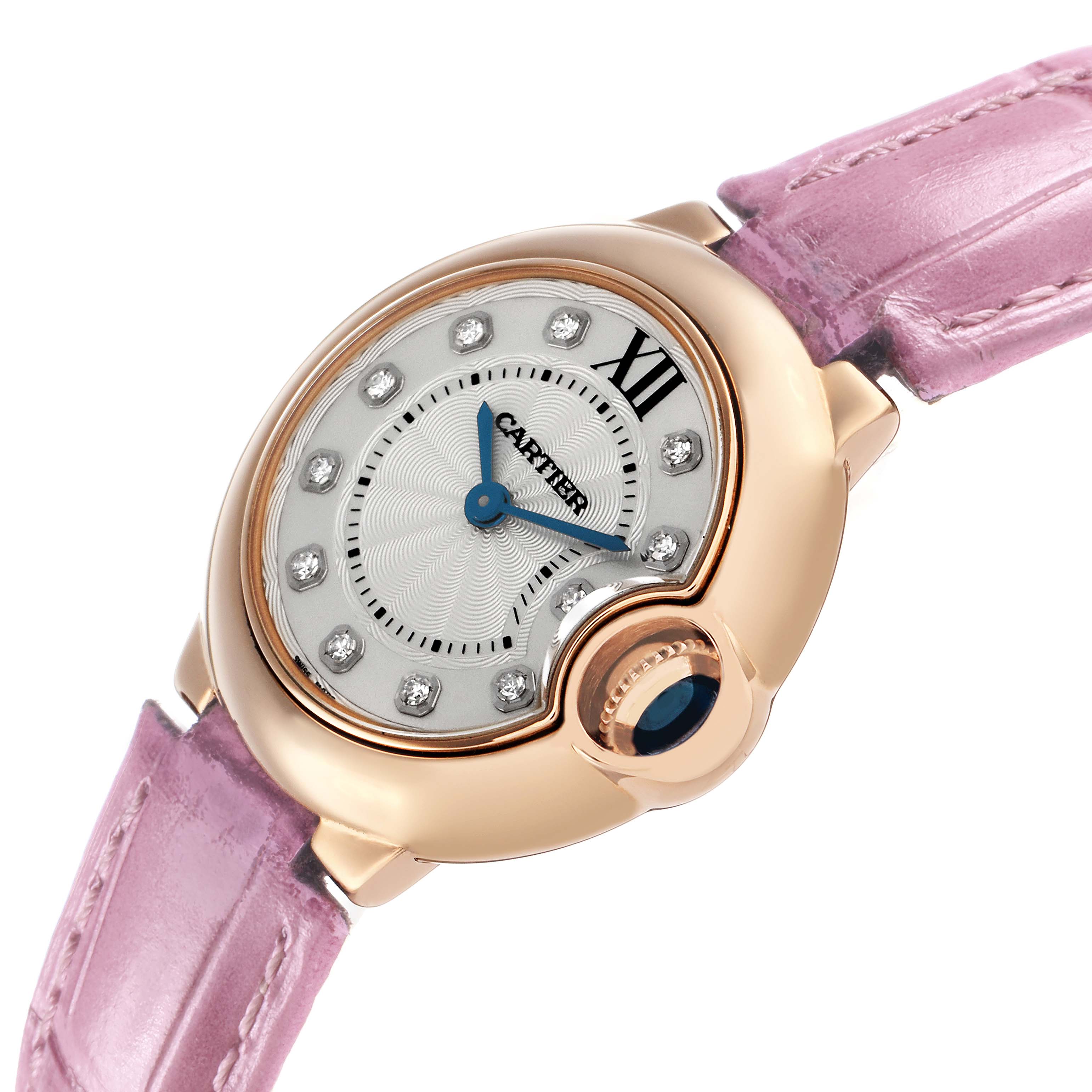 The Cartier Ballon Bleu WE902050 Women's Rose Gold Silver Dial watch is shown at an angled view, highlighting the face, crown, and pink strap.