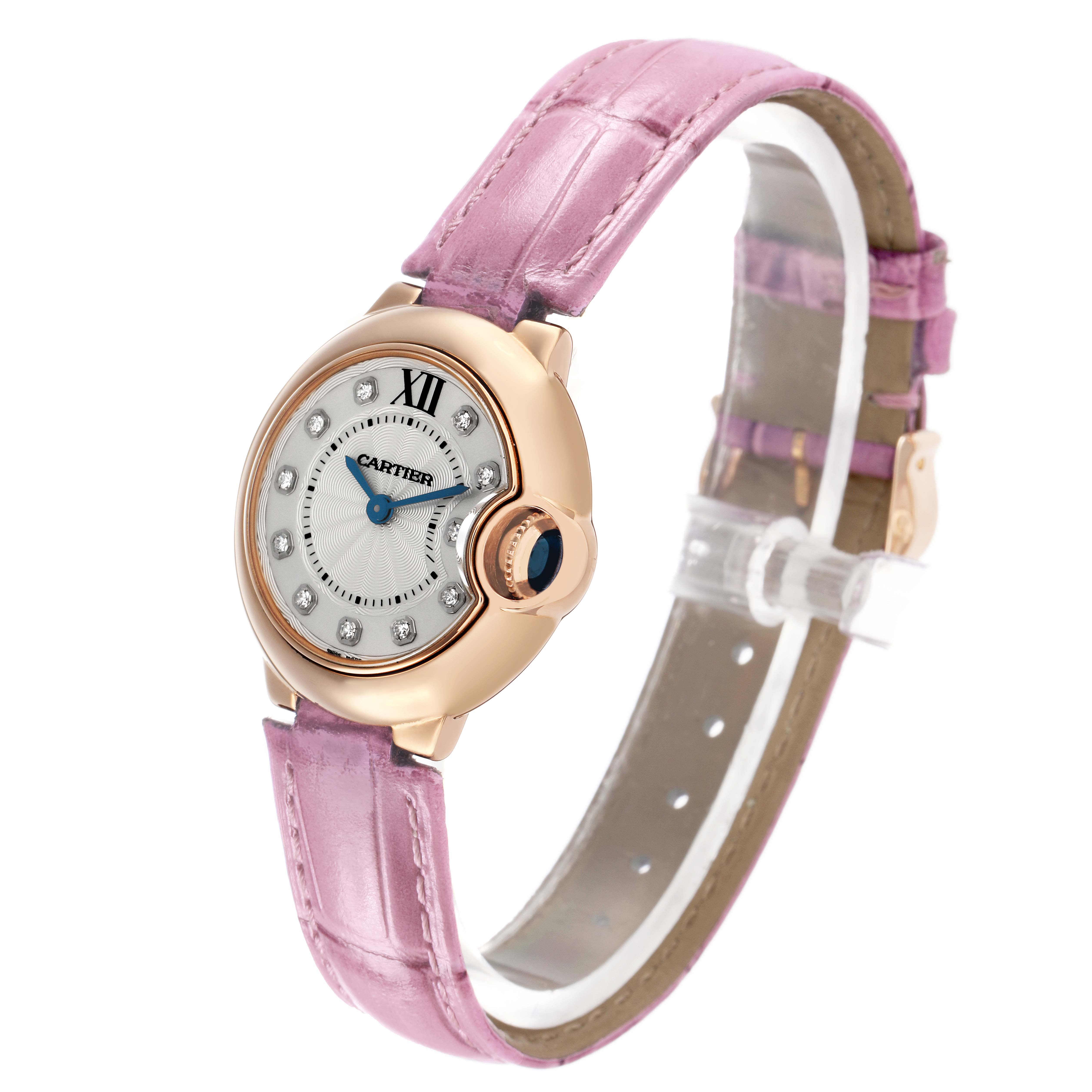 The Cartier Ballon Bleu WE902050 Women's Rose Gold Silver Dial is shown at a side angle, displaying the watch face, bezel, crown, and pink leather strap.