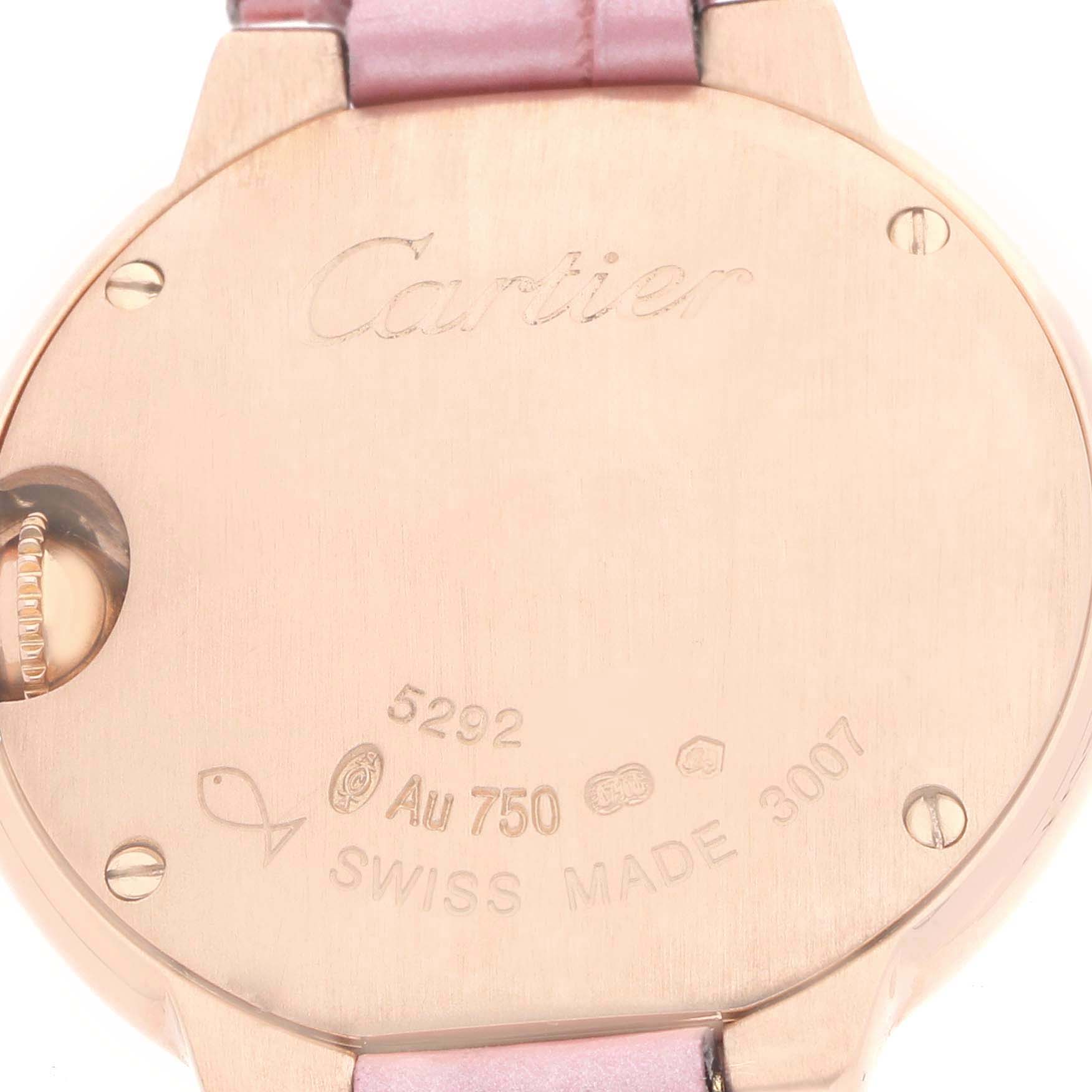 The image shows the back of the Cartier Ballon Bleu WE902050 Women's Rose Gold Silver Dial watch with engravings and a glimpse of the pink strap.