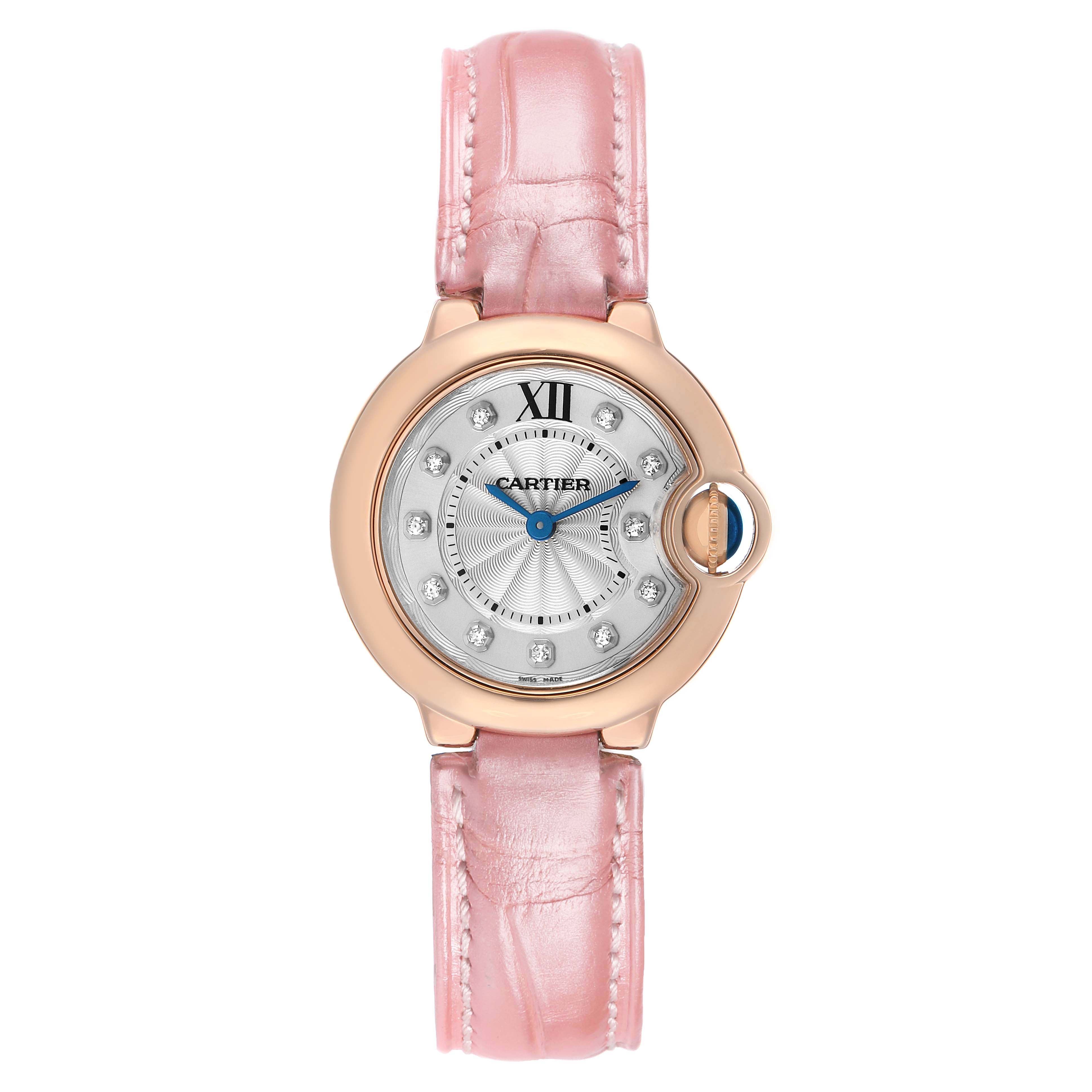 The Cartier Ballon Bleu WE902050 Women's Rose Gold Silver Dial watch is shown from a top view, highlighting the round face, pink strap, and diamond hour markers.