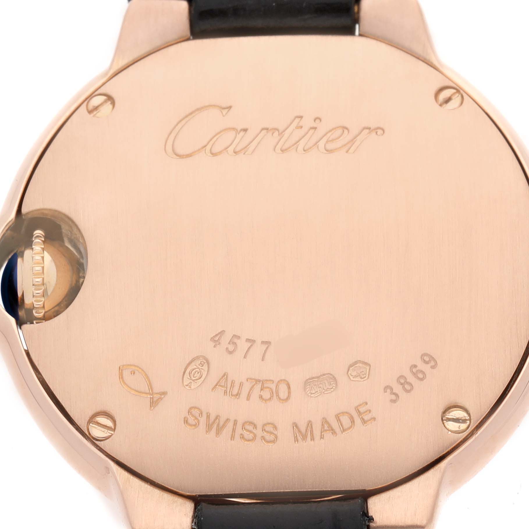 The image shows the back of a Ballon Bleu by Cartier, revealing the case back with engravings and part of the leather strap.
