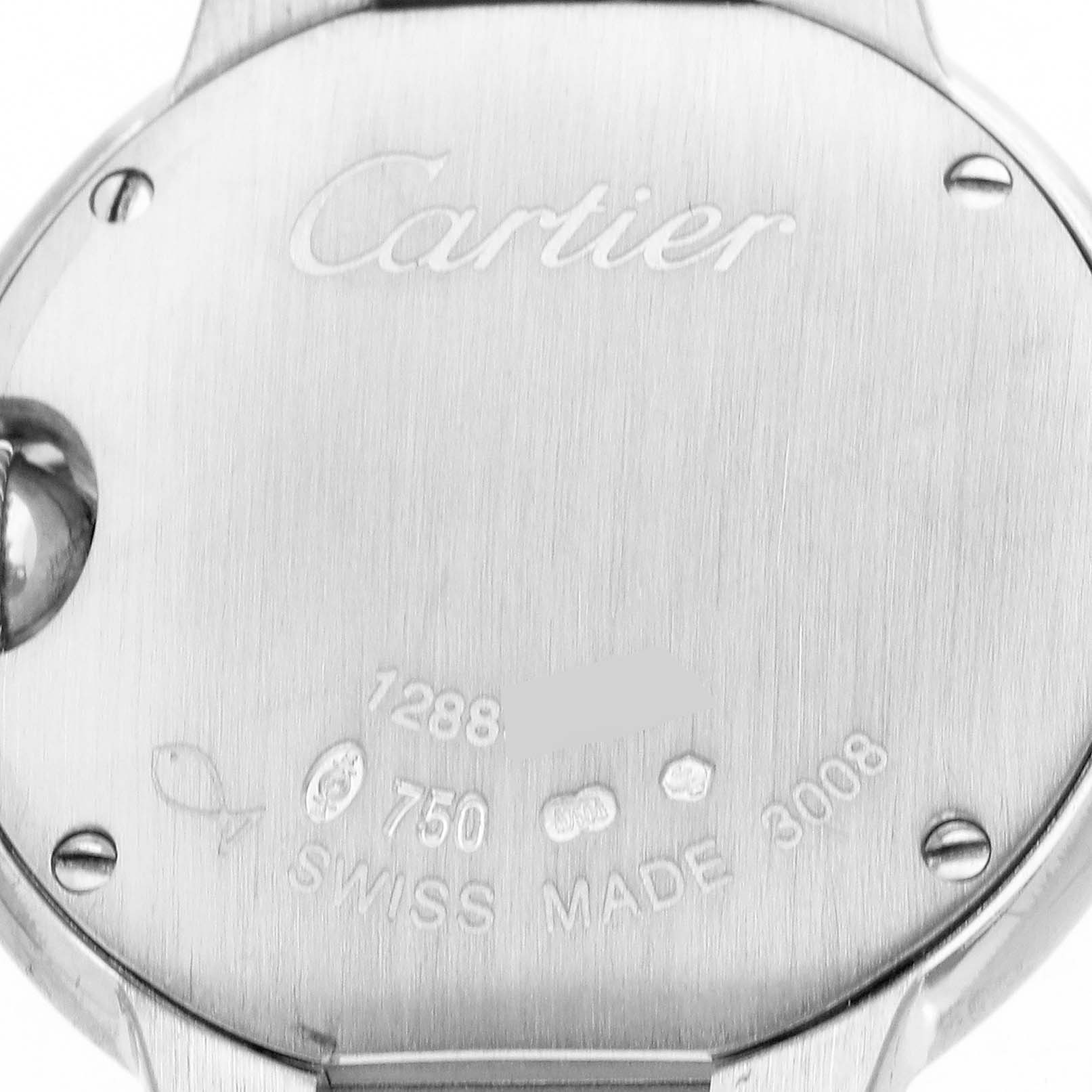 The image shows the back of a Cartier Ballon Bleu WE900351 Women's White Gold Silver Dial watch with engraved details and screws visible.