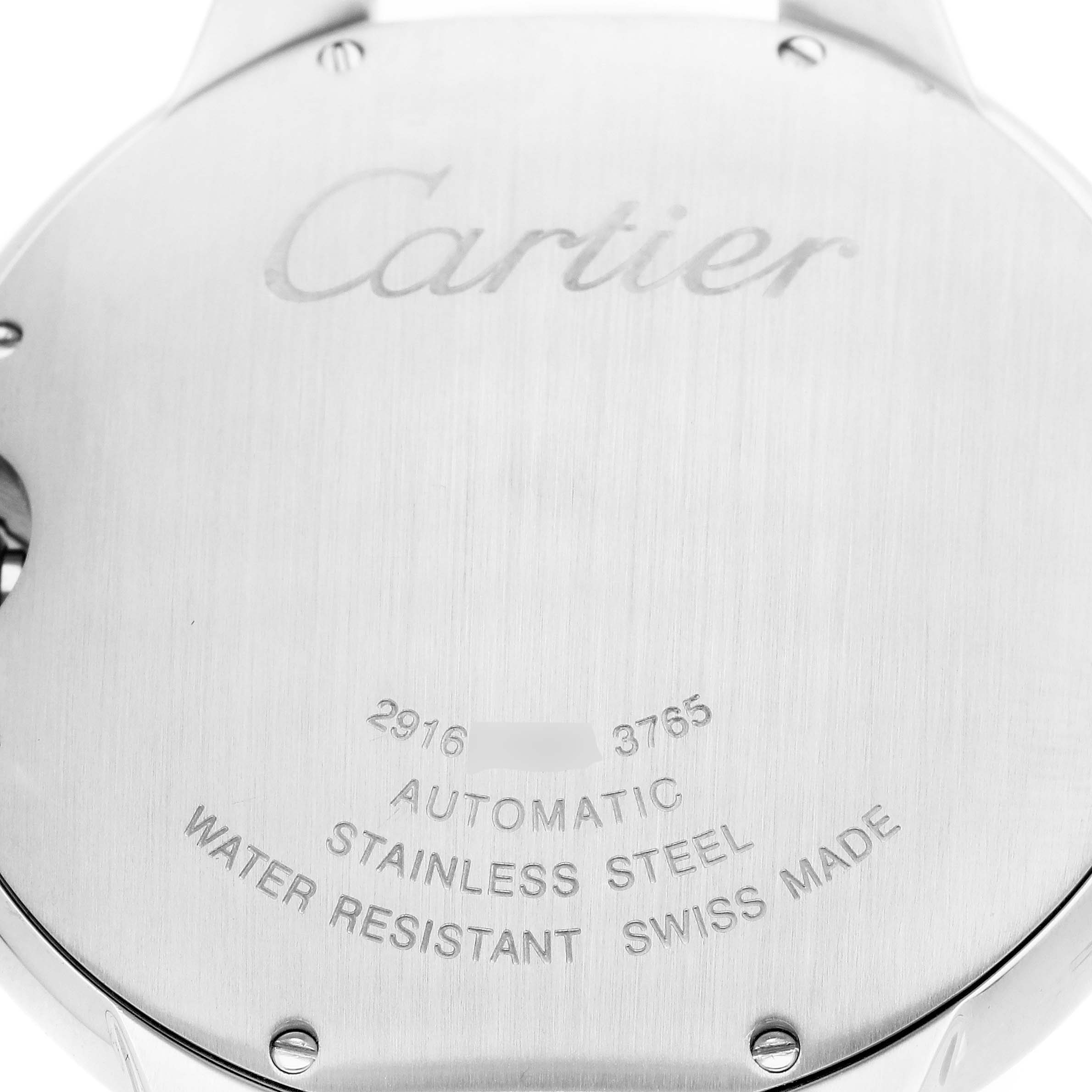 The image shows the back case of a Cartier Ballon Bleu W69016Z4 Men's Stainless Steel Silver Dial watch with engravings and screws visible.