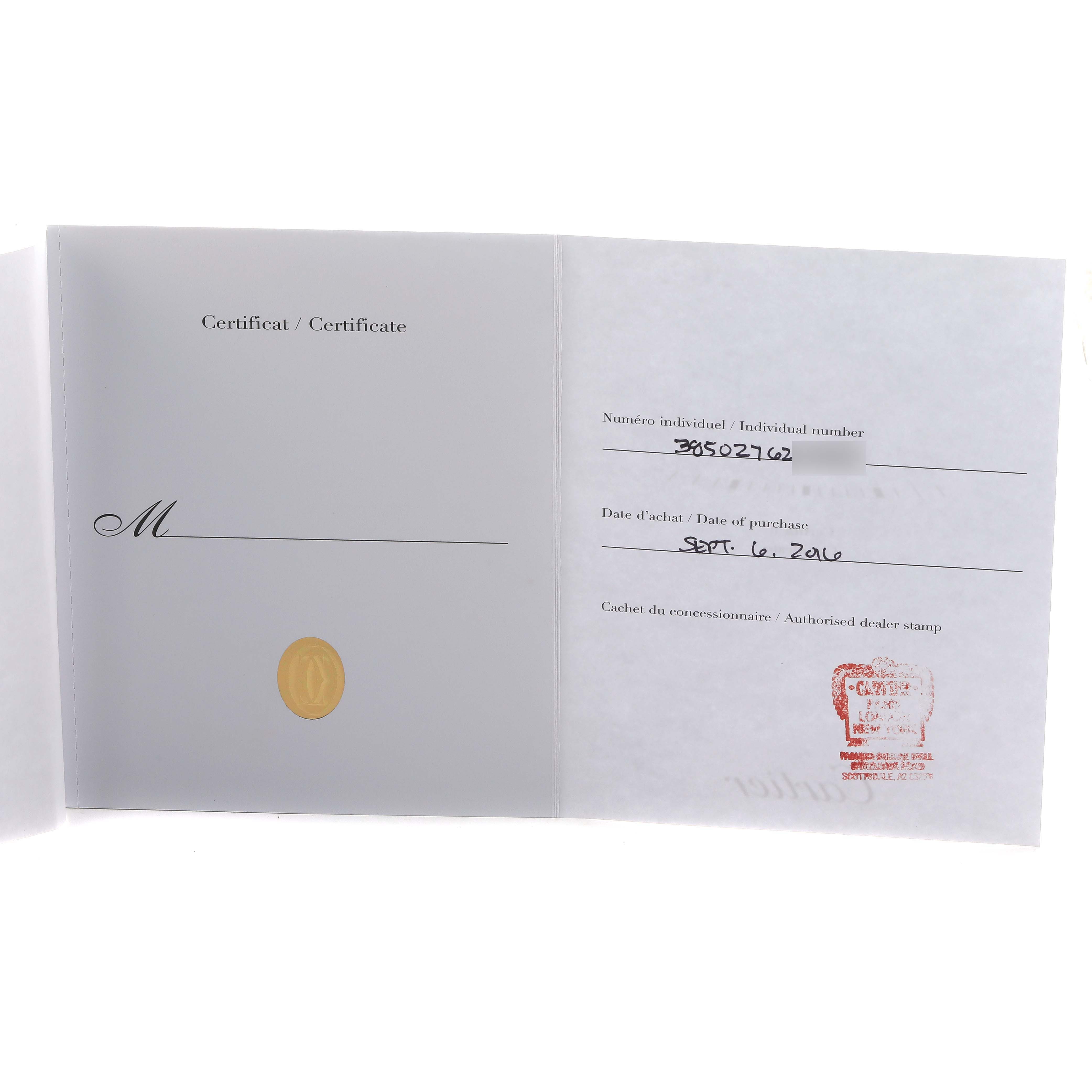 The image shows the warranty certificate for a Cartier Clé watch, featuring handwritten purchase details and a dealer stamp.