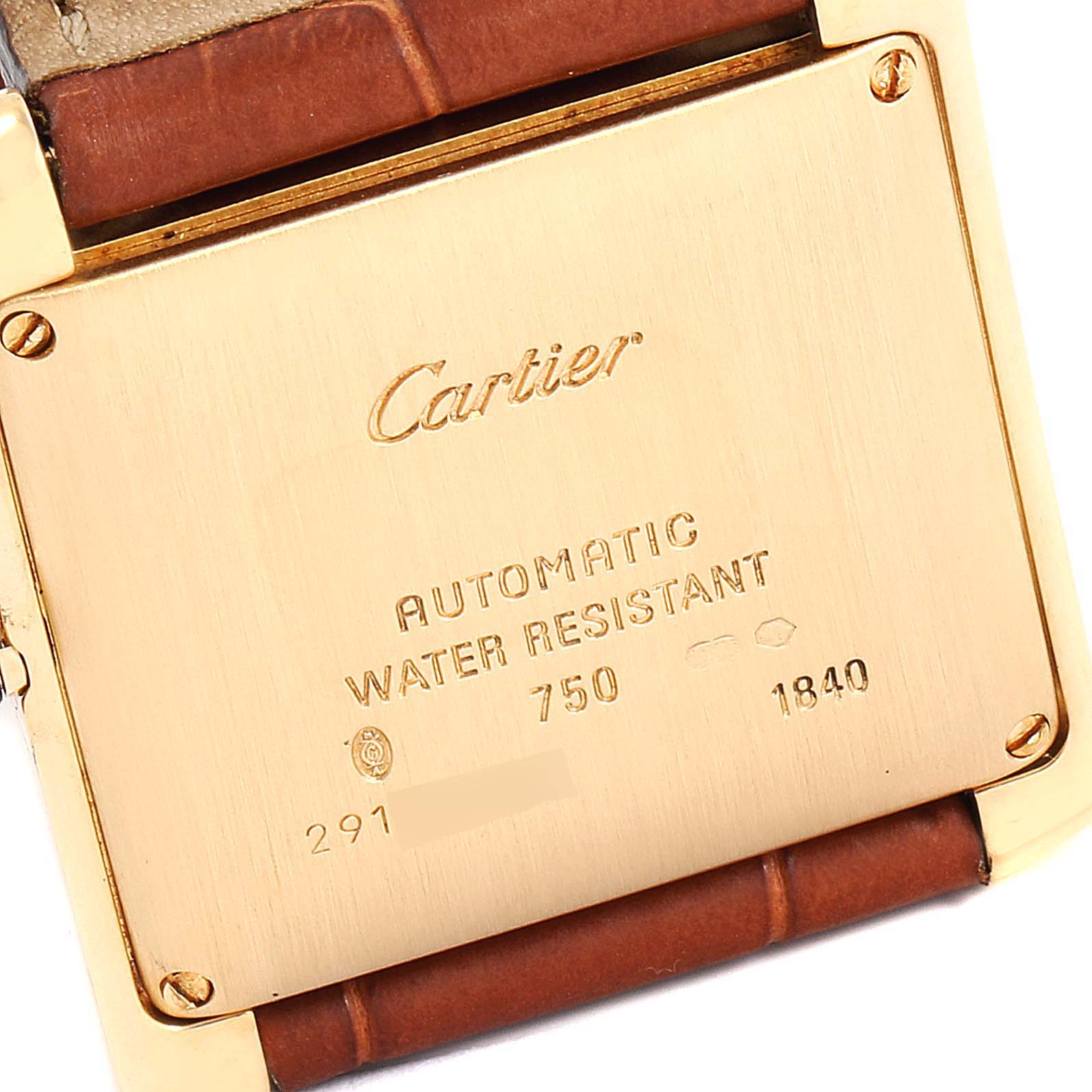 This image shows the back case of a Cartier Tank Française watch, including its engravings and a portion of the brown leather strap.