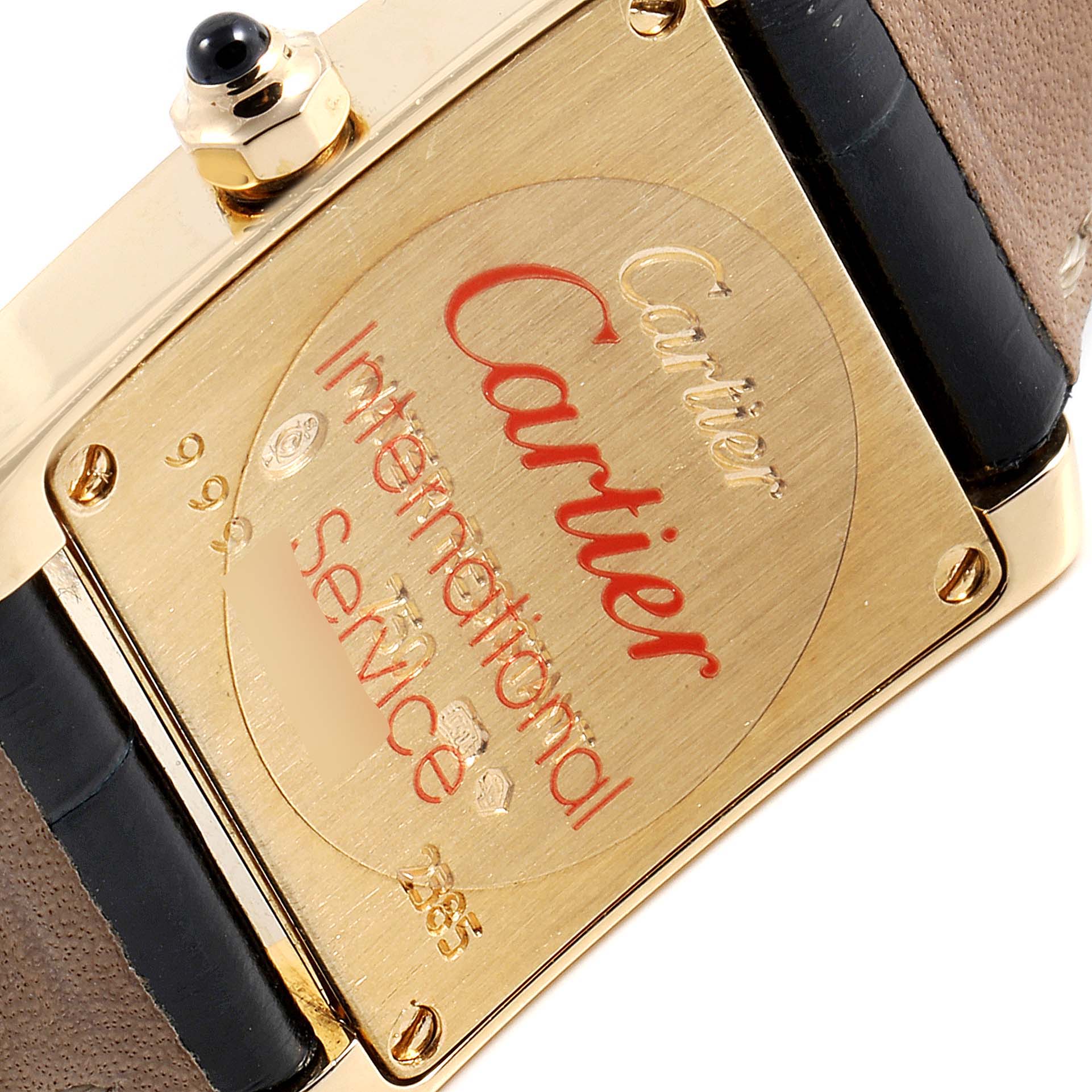 This image shows the back of a Cartier Tank Francaise W5000256 Women's Yellow Gold Silver Dial W5000256 Women's Yellow Gold Silver Dial watch, highlighting the engraved service details.