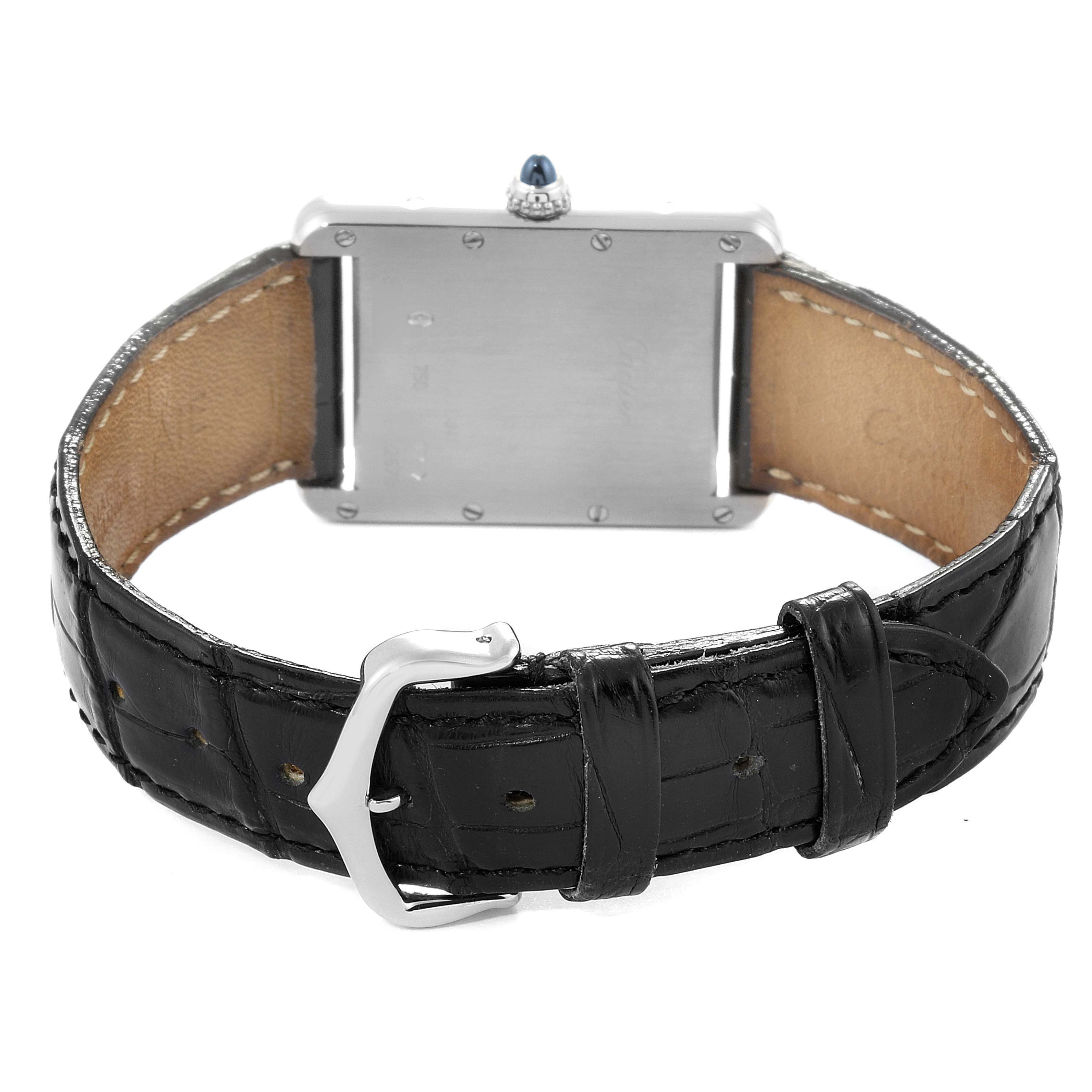 The image shows the back view of the Tank Louis model watch by Cartier, displaying the back case and black leather strap with a buckle.