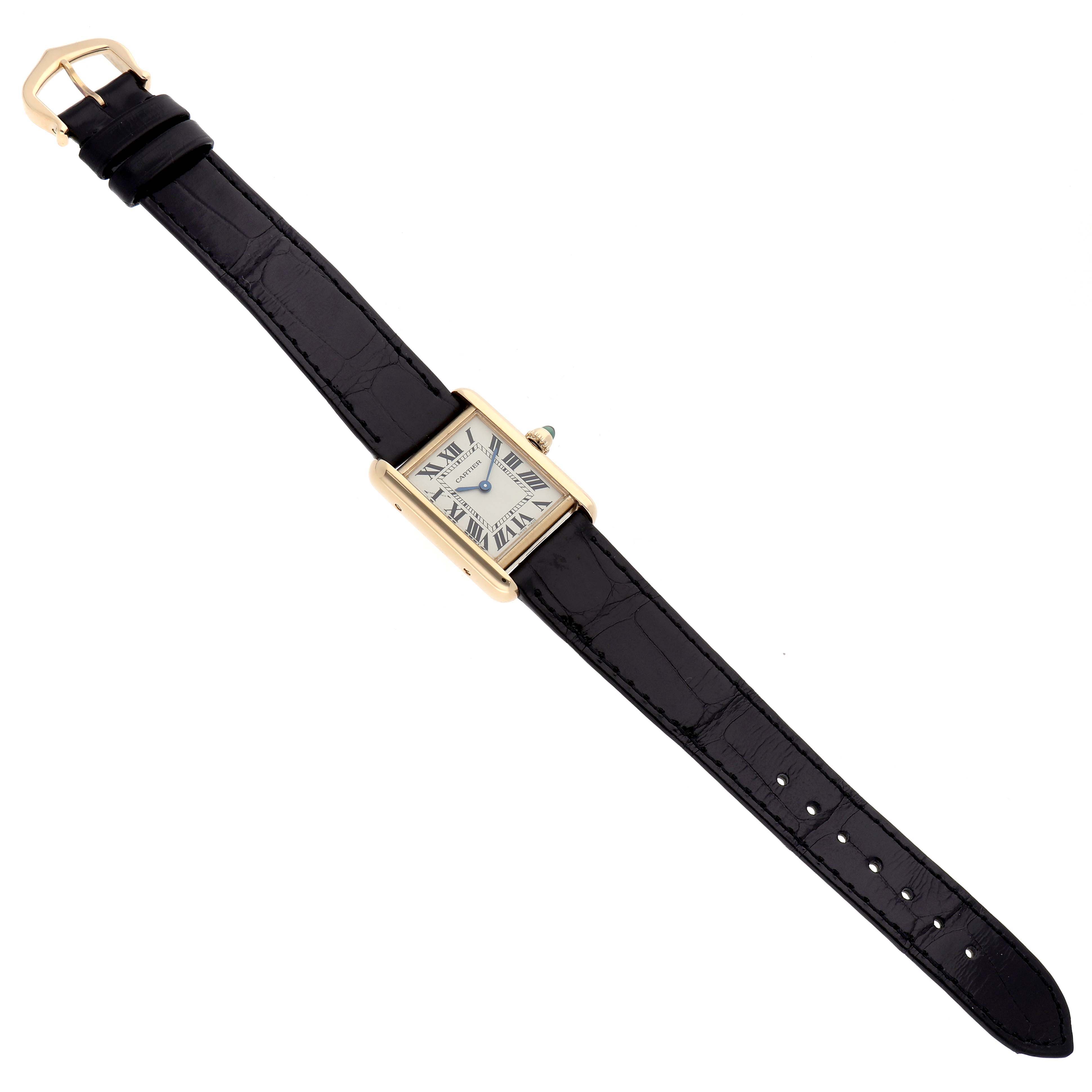 The Cartier Tank Louis W1529856 Women's Yellow Gold Silver Dial watch is shown from a top-down angle, displaying its face, case, and leather strap fully extended.
