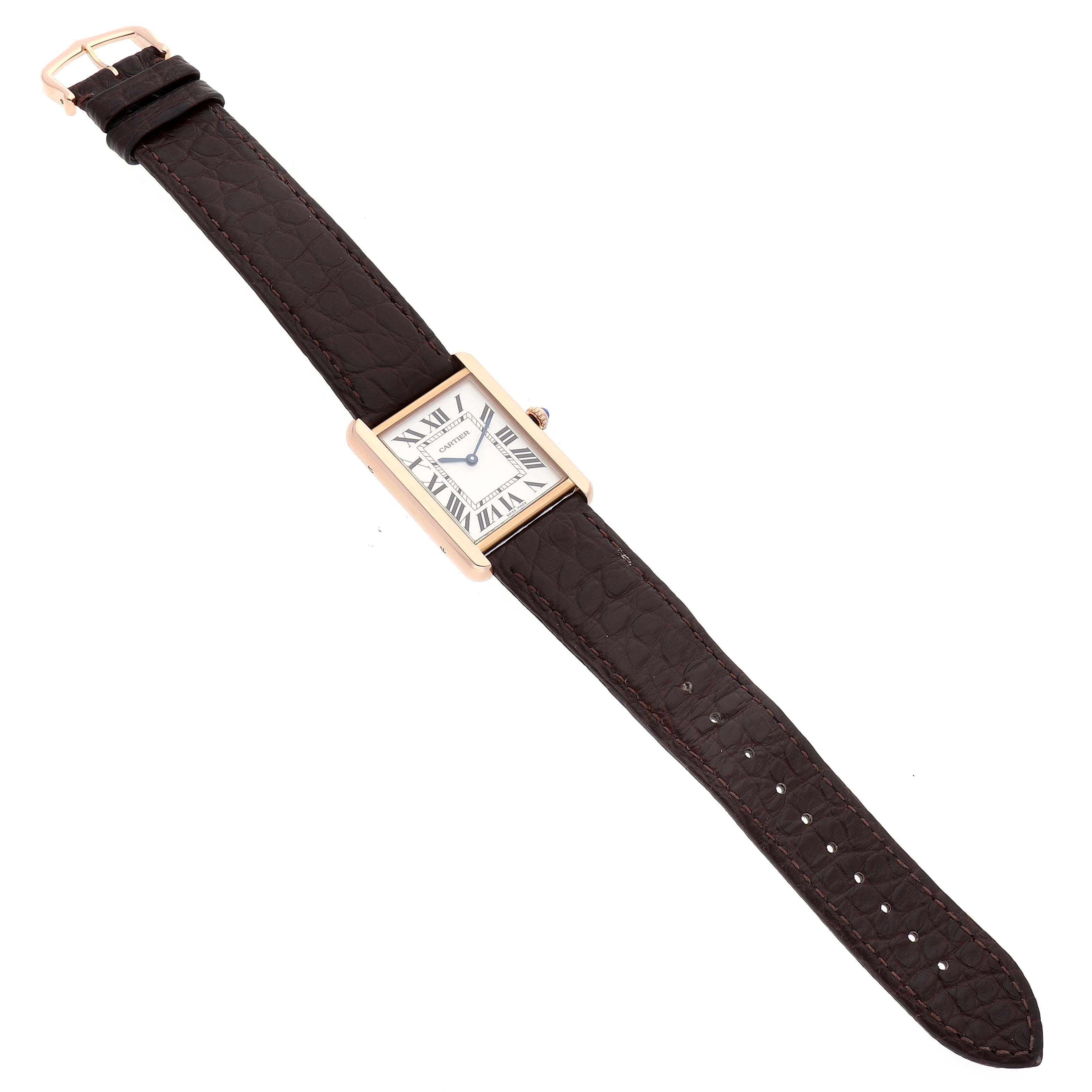 The image shows a Cartier Tank Solo W5200025 Men
s Rose Gold Silver Dial W5200025 Men
s Rose Gold Silver Dial watch from a top-down angle, displaying its rectangular face and brown leather strap.