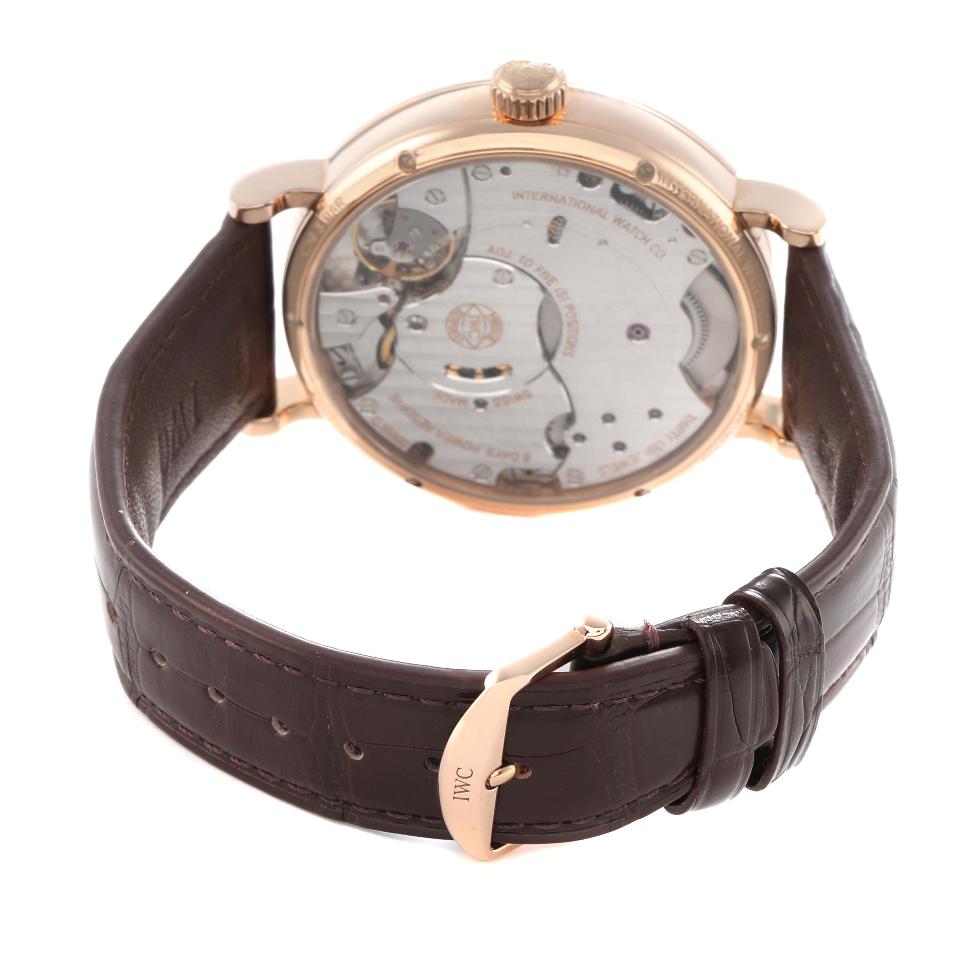 The IWC Portofino IW516403 Men's Rose Gold Grey Dial watch is shown from the back, displaying its movement through the transparent case and featuring a leather strap.