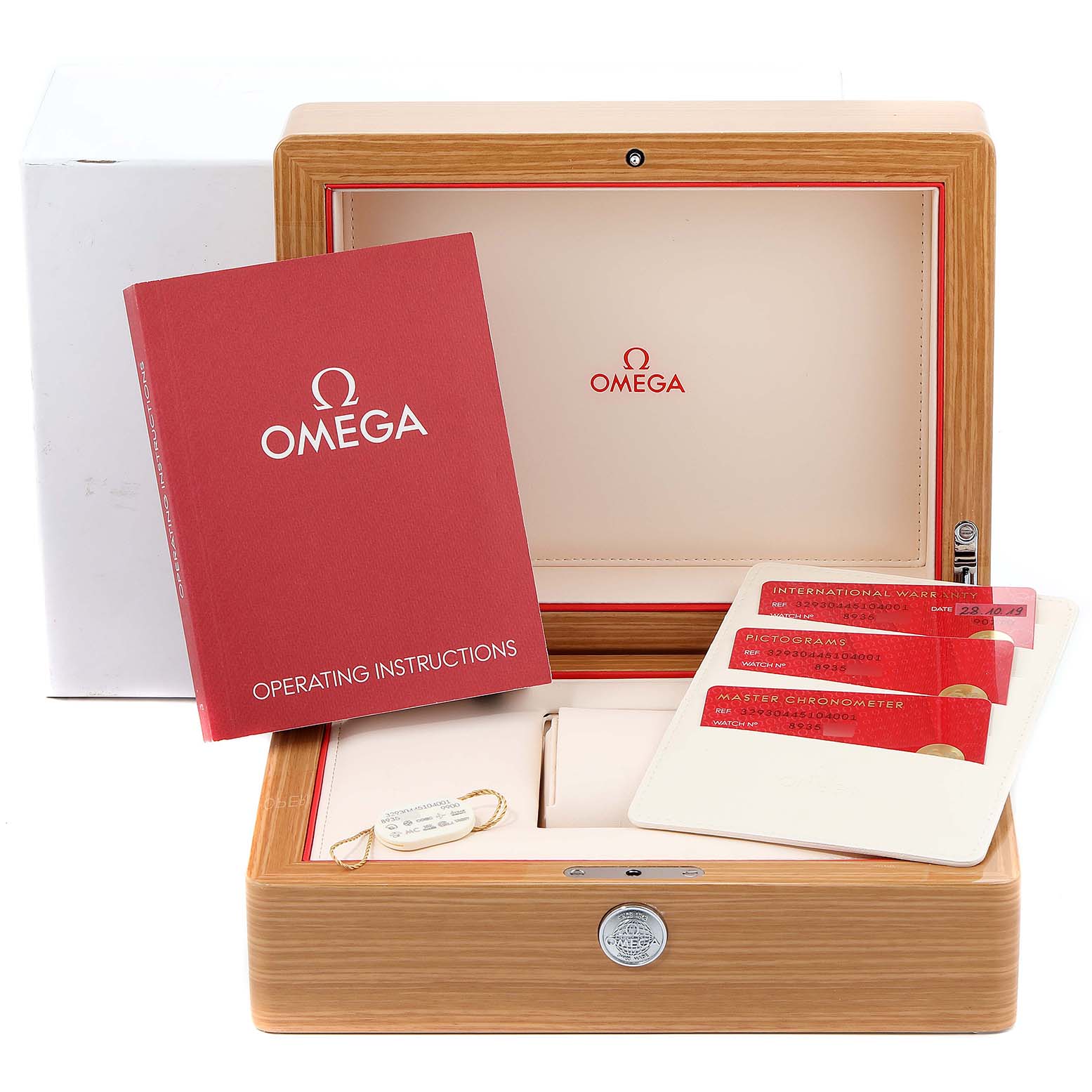 The image shows an Omega Speedmaster 40257 Men
s Stainless Steel White Dial 40257 Men
s Stainless Steel White Dial watch box with operating instructions and warranty cards at an angled top-down view.