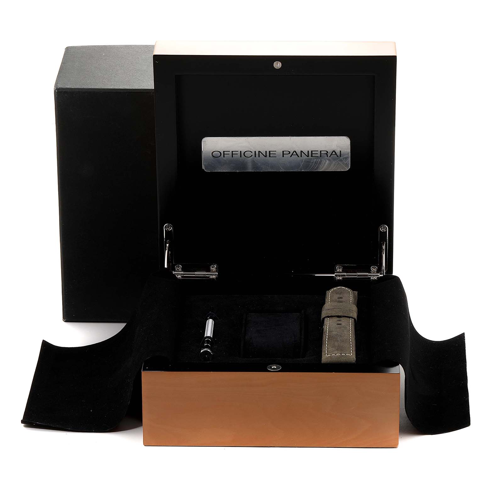 The image shows the open black and wooden case of a Panerai Luminor PAM00441 Men
s Stainless Steel Black Dial PAM00441 Men
s Stainless Steel Black Dial, displaying watch accessories including a strap and tool.