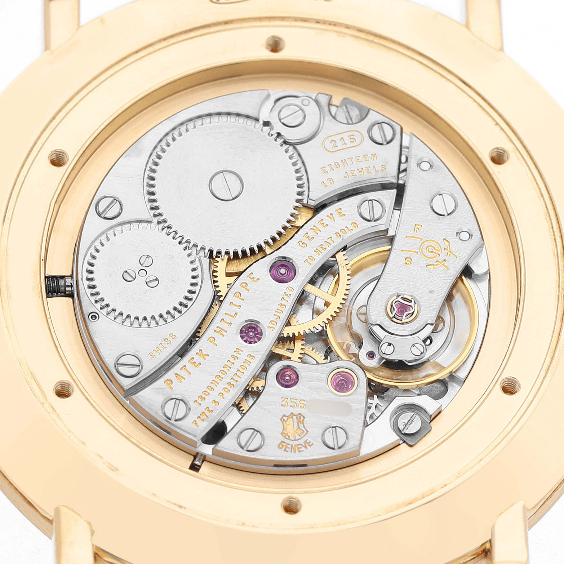 The image shows the back view of the Patek Philippe Calatrava 5119J-001 Men's Yellow Gold White Dial, highlighting its intricate movement and gears.