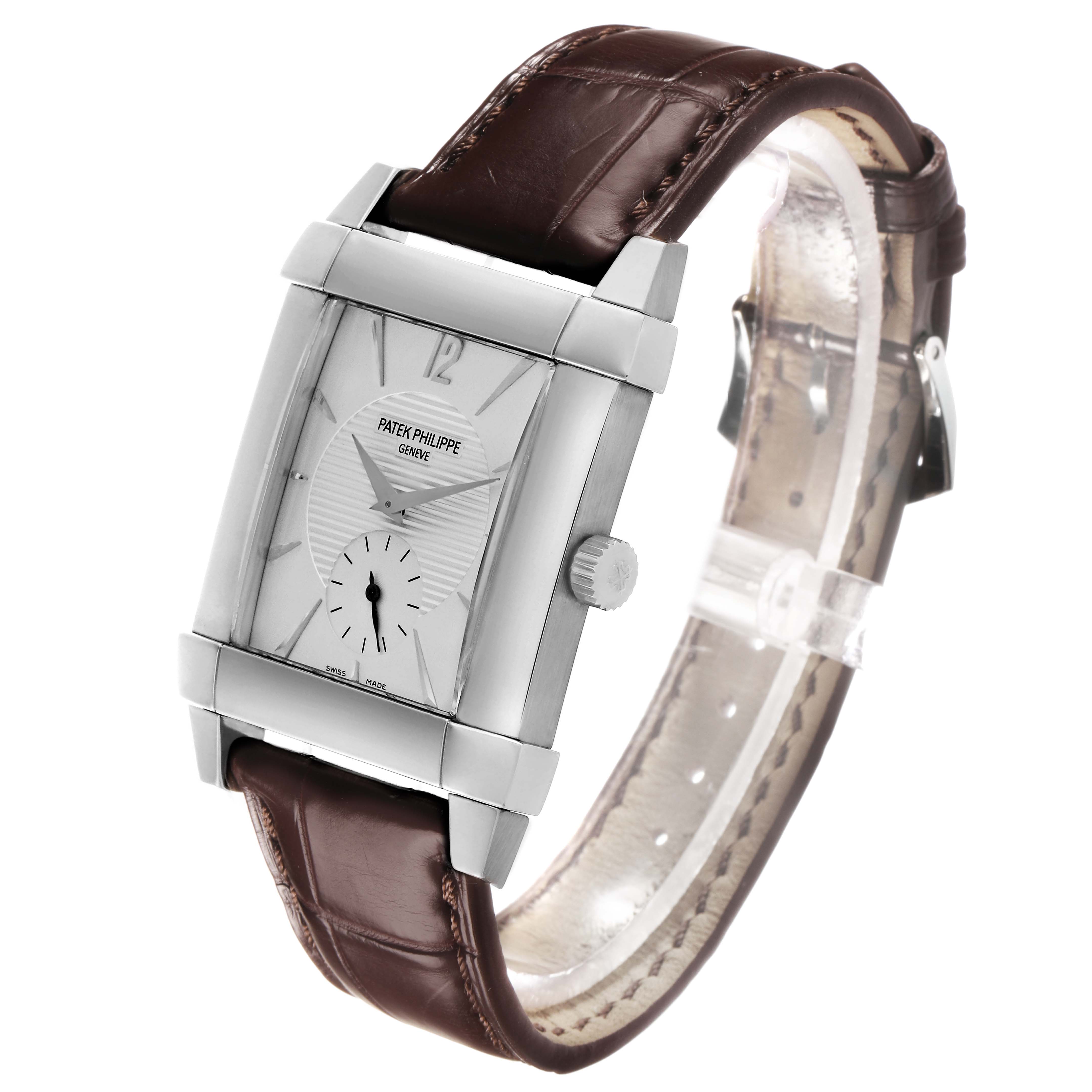 The Patek Philippe Gondolo 5111G Men's White Gold Silver Dial watch is shown at an angled top view, highlighting the rectangular case, silver dial, and brown leather strap.
