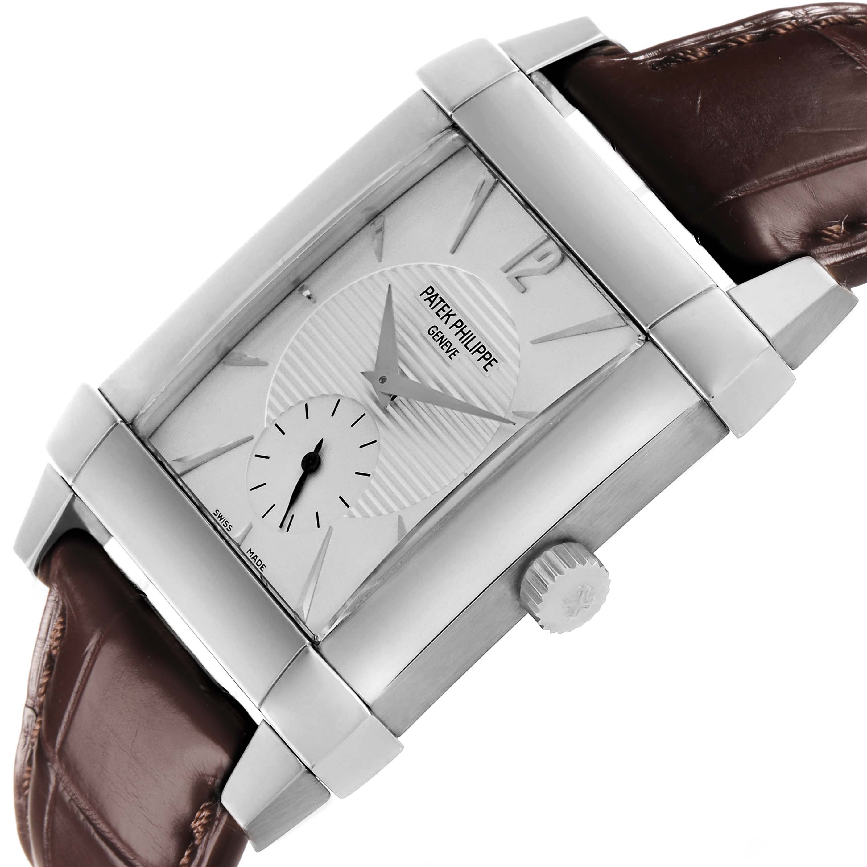 The Patek Philippe Gondolo 5111G Men's White Gold Silver Dial watch is shown from an angle highlighting the face, crown, and brown leather strap.