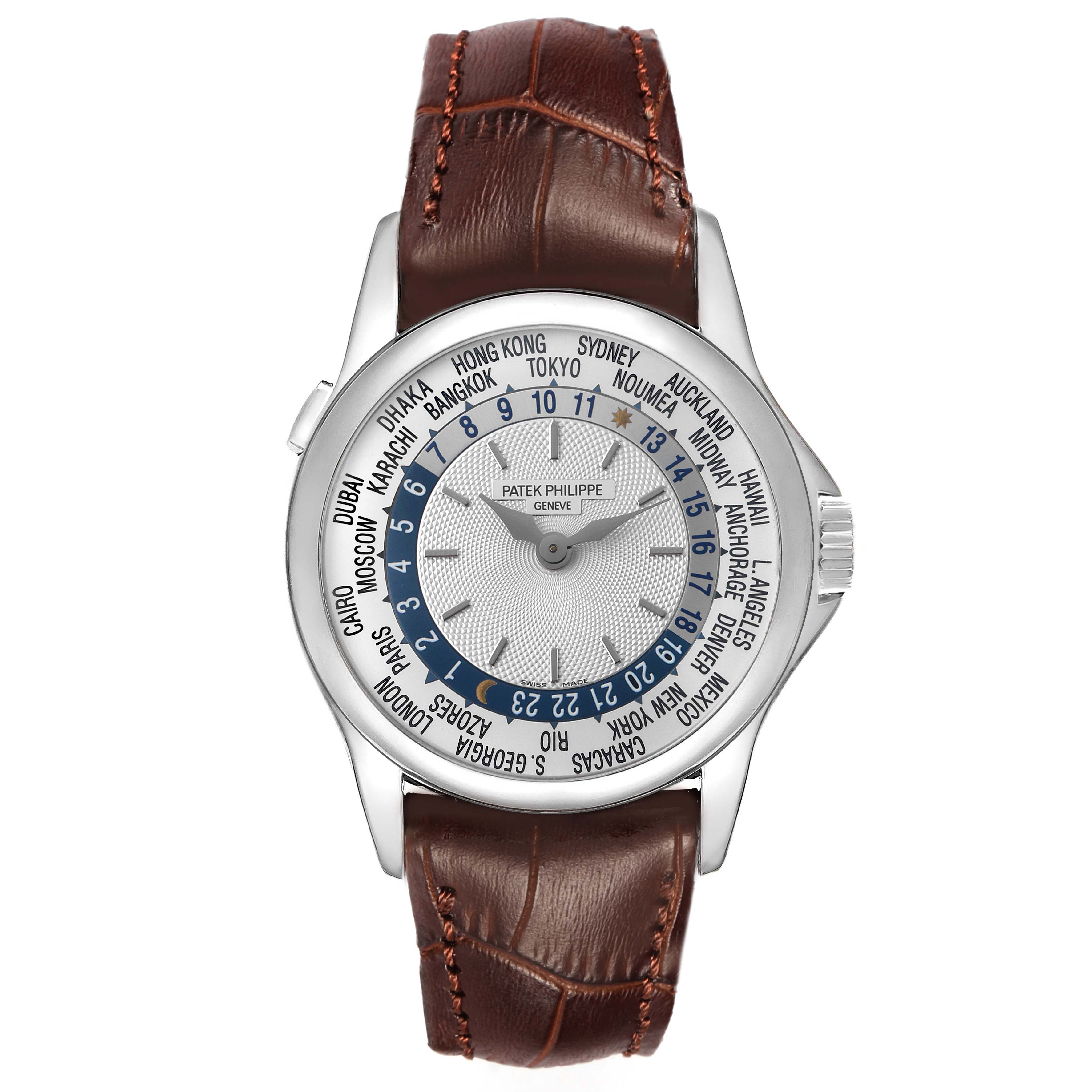 The image shows a Patek Philippe Complications 5110G Men's White Gold Silver Dial watch from a top-down angle, highlighting its face, hands, world time cities, and leather strap.