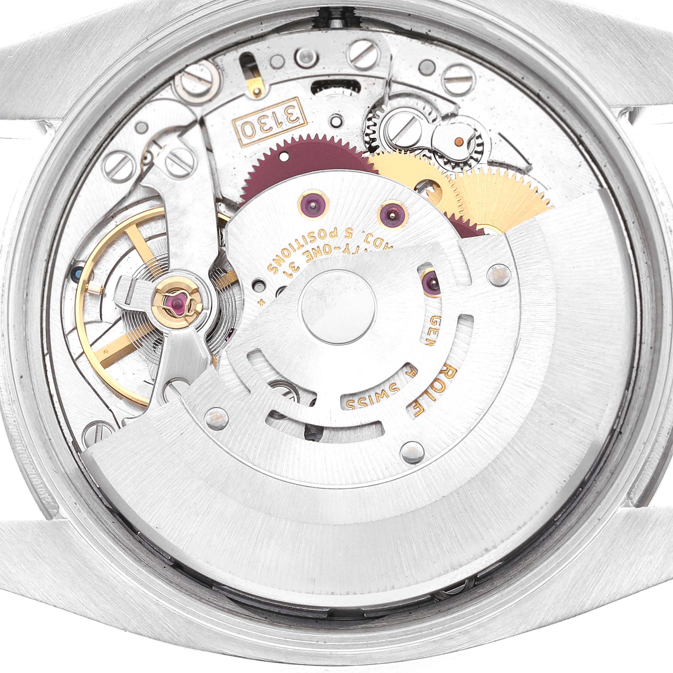 This image shows the internal mechanism of a Rolex Air-King 114234 Men's Stainless Steel White Dial 114234 Men's Stainless Steel White Dial watch viewed from the back case, revealing gears and the rotor.