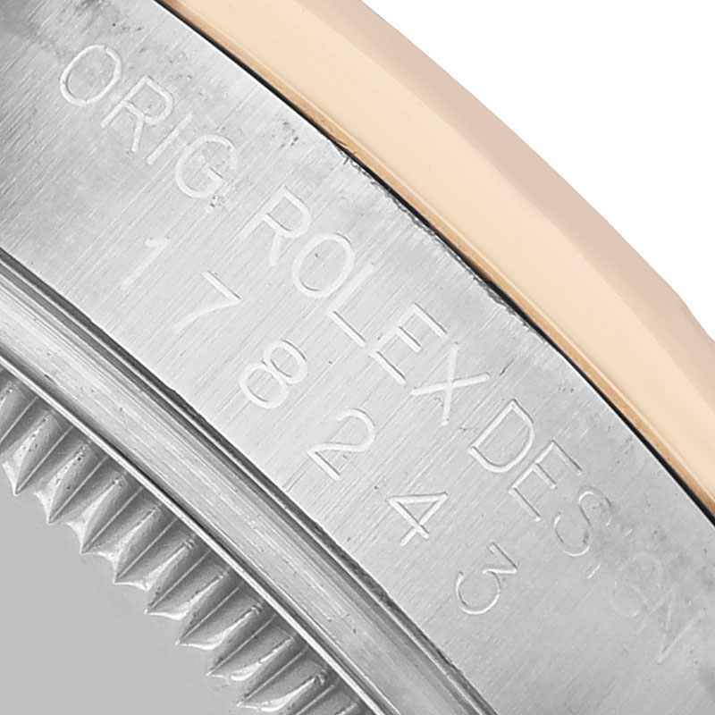 The image shows a close-up of the case side with engravings on a Mid-Size Rolex watch.
