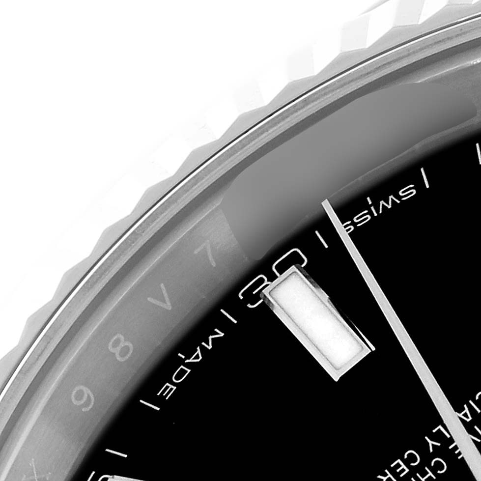 This close-up image of the Rolex Datejust 41 126334 Men
s Stainless Steel Black Dial 126334 Men
s Stainless Steel Black Dial watch shows the bezel, dial, and part of a date indicator.
