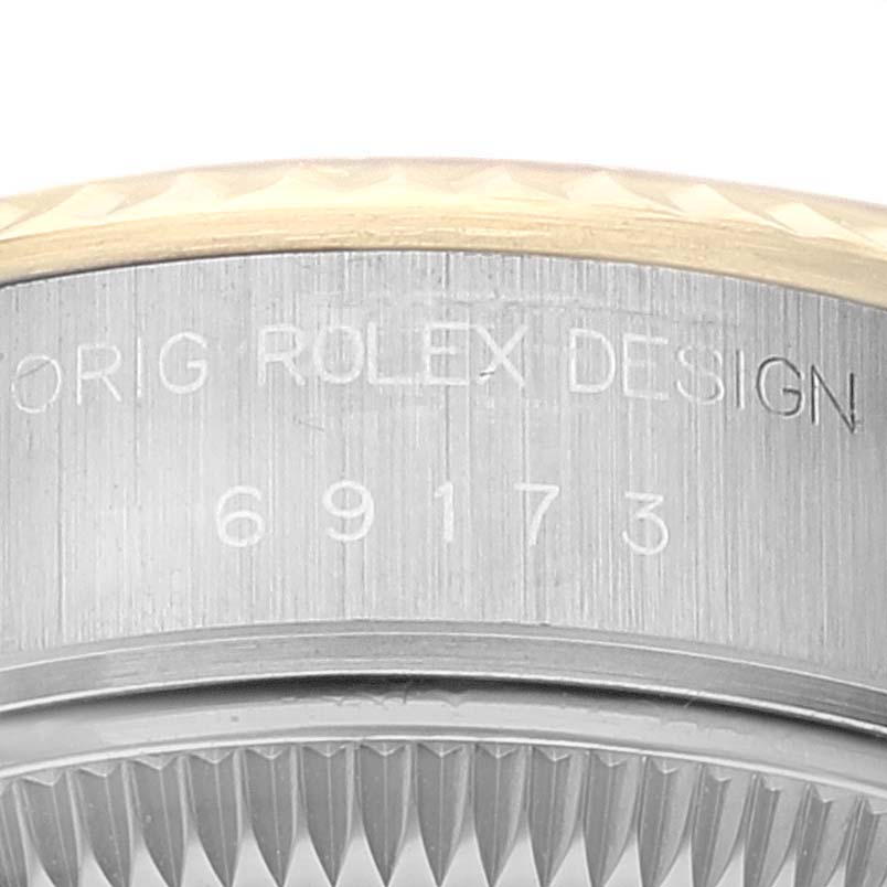 This image shows the side of the bezel and caseback of a Rolex Datejust 69173 Women's Steel and Gold (two tone) Black Dial 69173 Women's Steel and Gold (two tone) Black Dial, highlighting the engraved model number and "Orig Rolex Design."