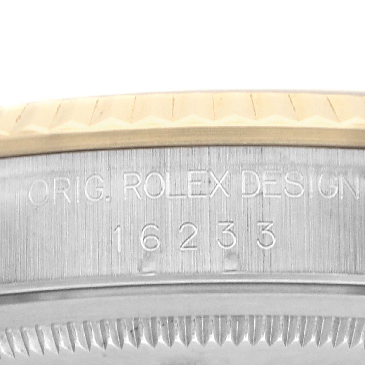 The image shows a close-up of the side edge of a Rolex Datejust 16233 Men's Steel and Gold (two tone) Champagne Dial, highlighting the engraved "ORIG. ROLEX DESIGN" and model number.