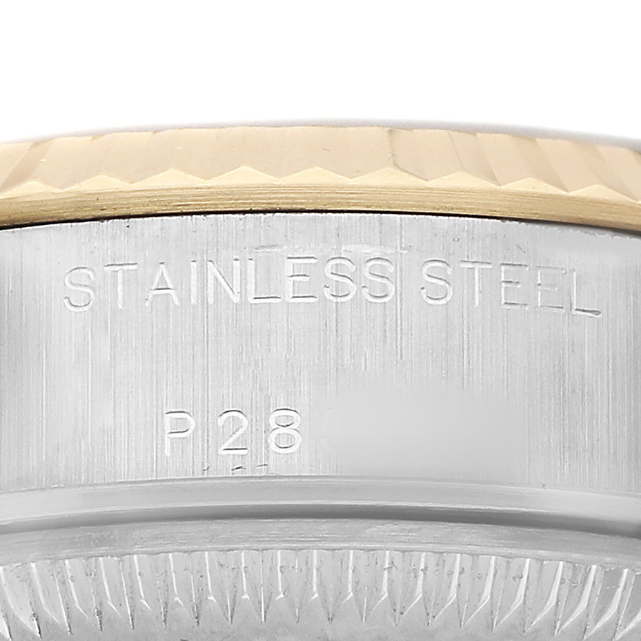 The image shows a close-up of the side of a Rolex Datejust 79173 Women's Stainless Steel Blue Dial, highlighting the bezel and stainless steel engraving.