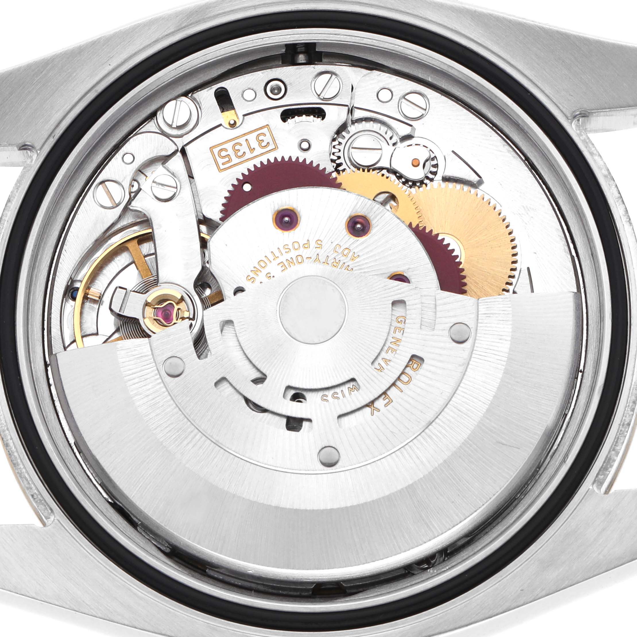 The image shows the movement of a Rolex Datejust 116233 Men's Steel and Gold (two tone) Blue Dial watch from a back view, displaying gears and mechanical components.
