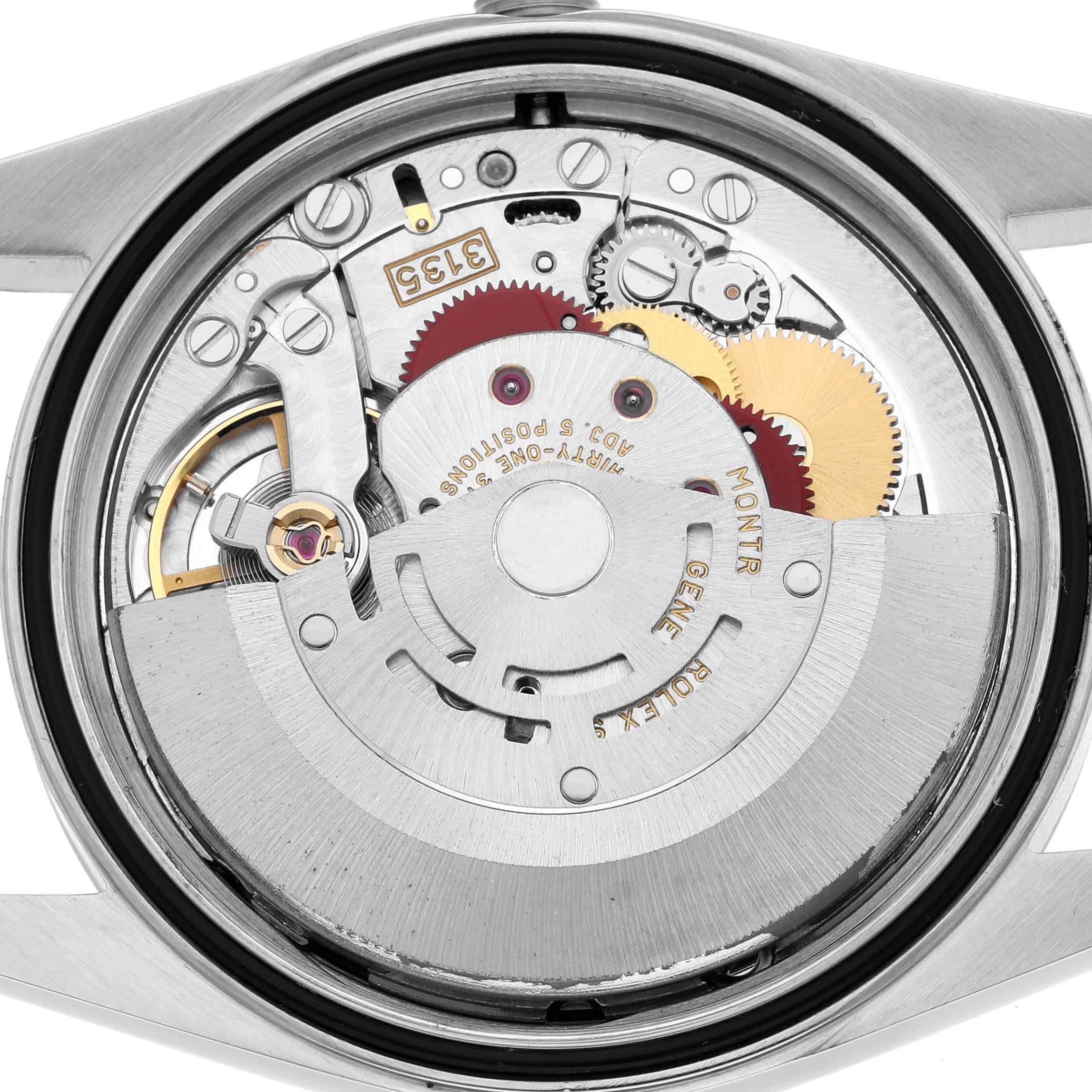 The image shows the movement mechanism of a Rolex Datejust 16233 Men's Steel and Gold (two tone) White Dial watch from a back angle, highlighting gears and the rotor.