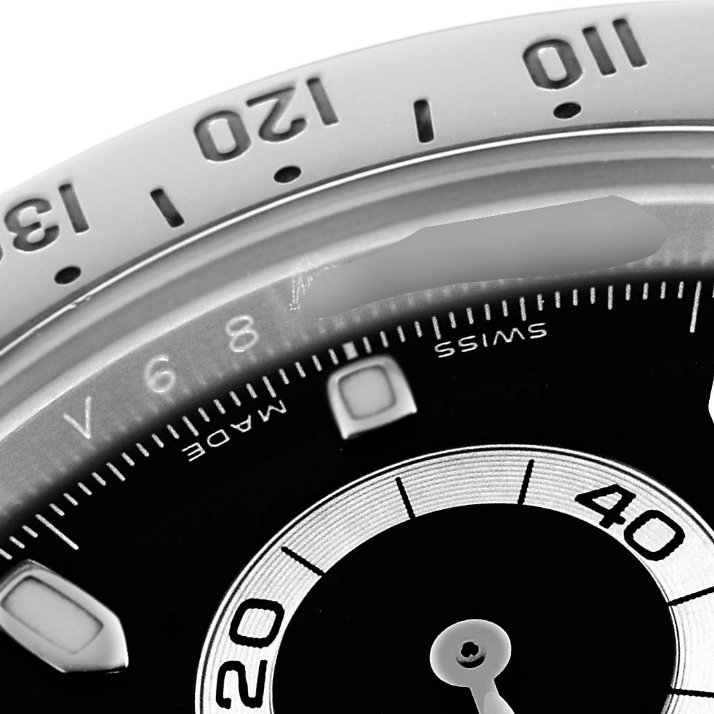 The image shows a close-up of the bezel and part of the dial of a Rolex Daytona 116520 Men's Stainless Steel Black Dial watch, with visible tachymetric scale and subdial.