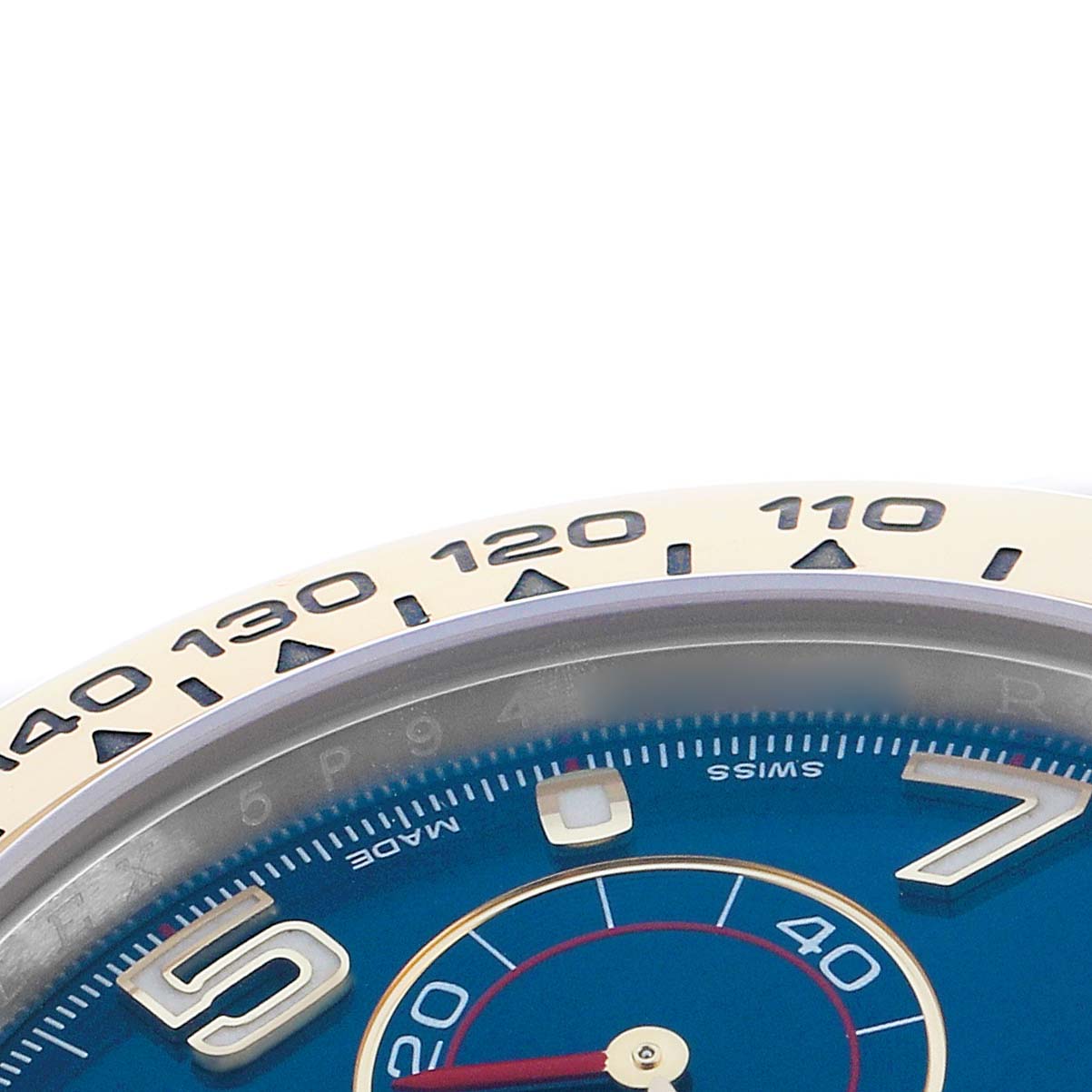 The image shows a close-up of the Rolex Daytona 116503 Men's Steel and Gold (two tone) Blue Dial watch, displaying part of the bezel with tachymetric scale and a portion of the blue dial.