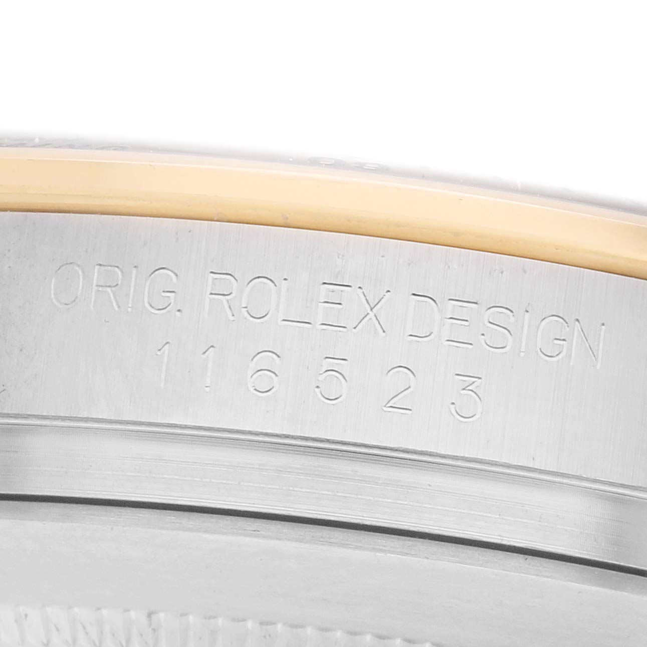 The image shows a close-up of a Rolex Daytona 116523 Men's Steel and Gold (two tone) Blue Dial model's case edge with the engraved design number.