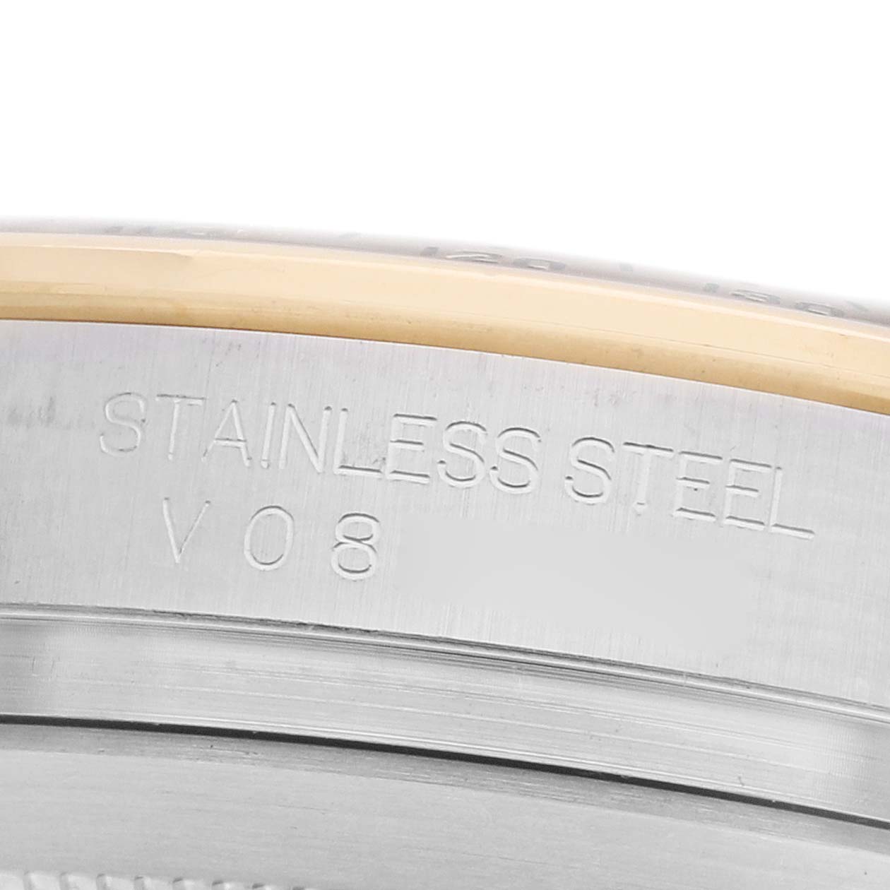 The image shows a close-up of the side of a Rolex Daytona 116523 Men's Steel and Gold (two tone) Blue Dial watch case, highlighting the stainless steel material.