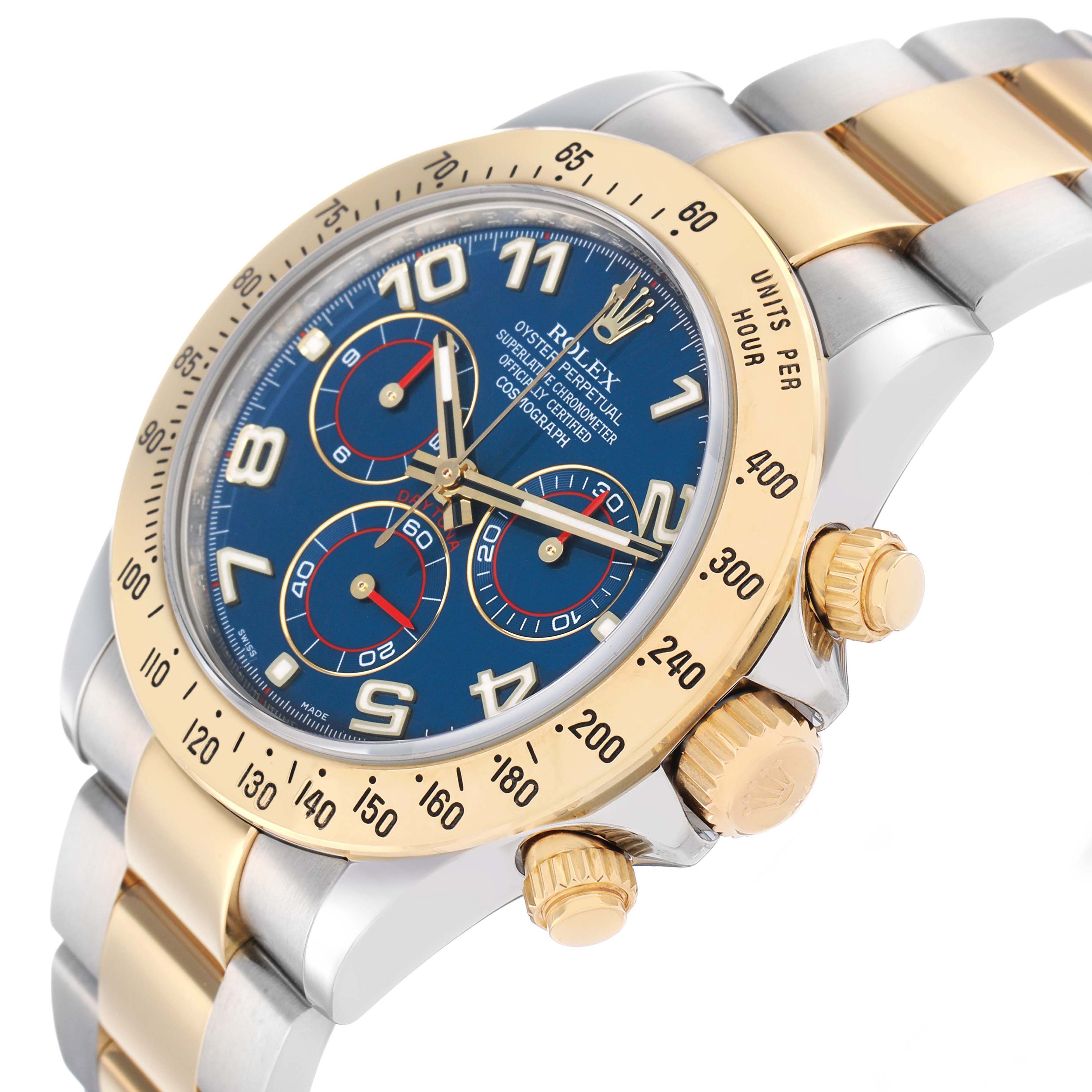 The Rolex Daytona 116523 Men's Steel and Gold (two tone) Blue Dial watch is shown at a three-quarter angle, highlighting the bezel, crown, pushers, and dual-tone bracelet.