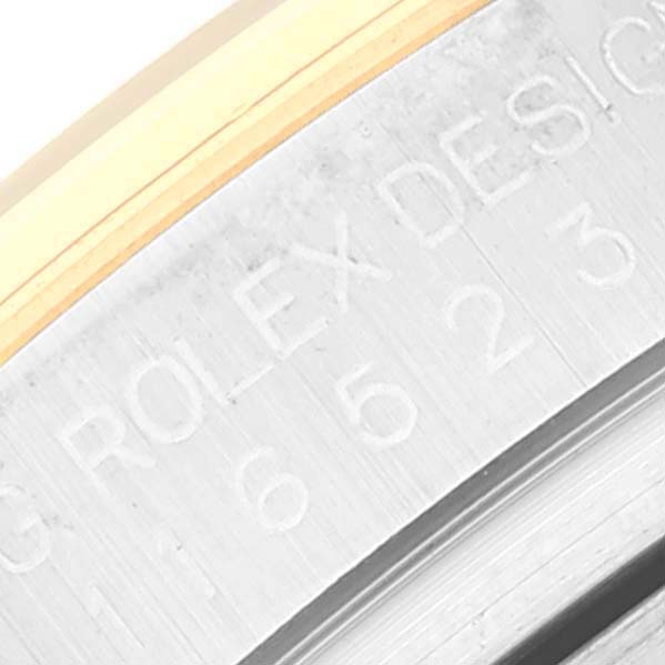 The image shows a close-up of the case side of a Rolex Daytona 116523 Men's Steel and Gold (two tone) Blue Dial 116523 Men's Steel and Gold (two tone) Blue Dial watch, highlighting the engraved text.