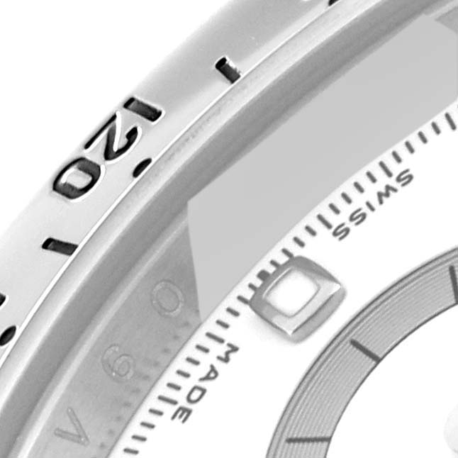 The image shows a close-up view of the dial and bezel of a Rolex Daytona 116520 Men's Stainless Steel White Dial 116520 Men's Stainless Steel White Dial watch, highlighting the numerals and part of the chronograph.