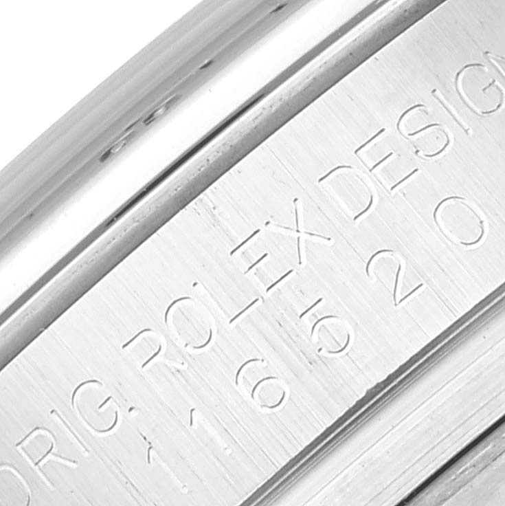 This close-up image shows the engraved edge of the caseback of a Rolex Daytona 116520 Men's Stainless Steel White Dial 116520 Men's Stainless Steel White Dial watch.