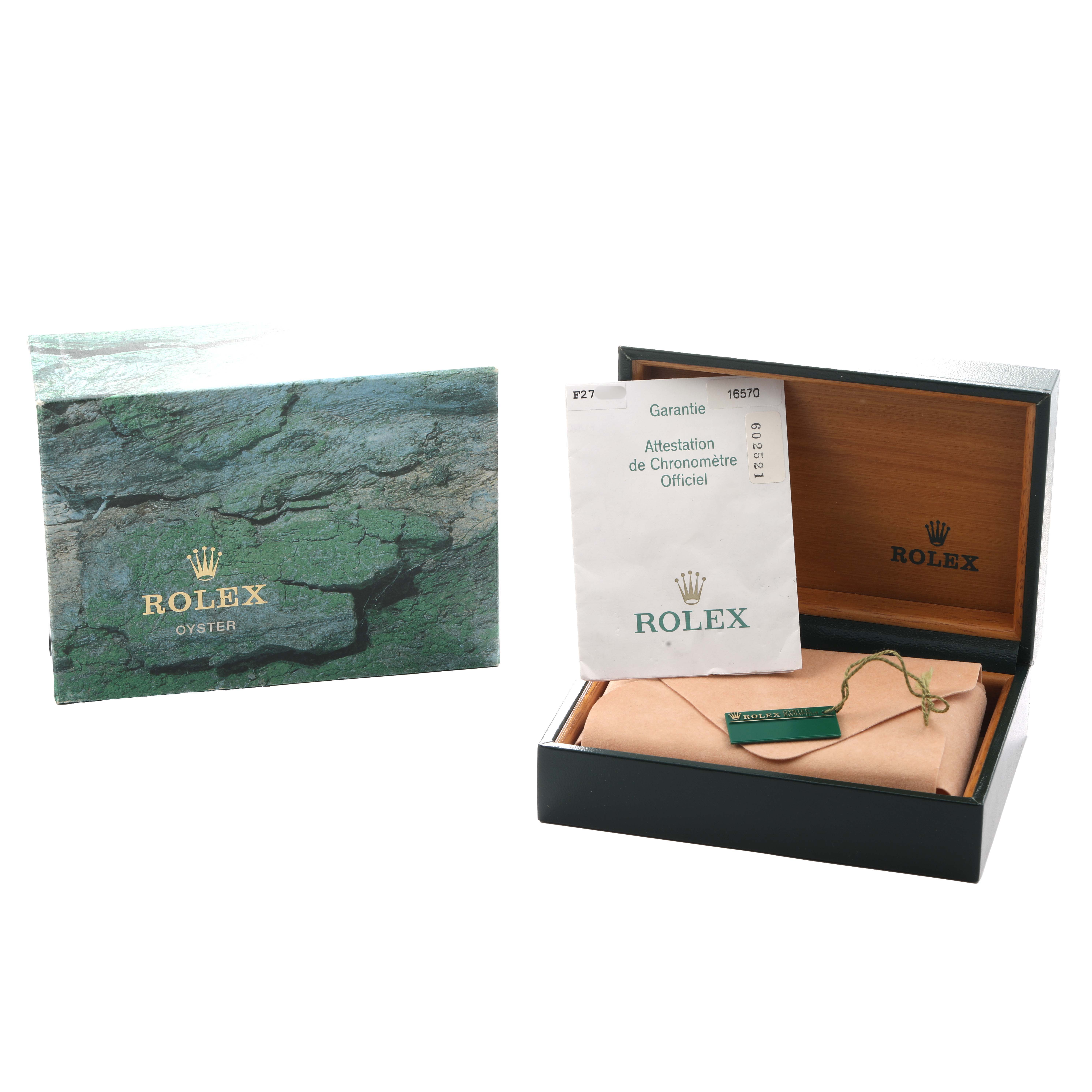 The image shows the packaging and warranty card of a Rolex Explorer 16570 Men's Stainless Steel White Dial, including the outer box and inner case.