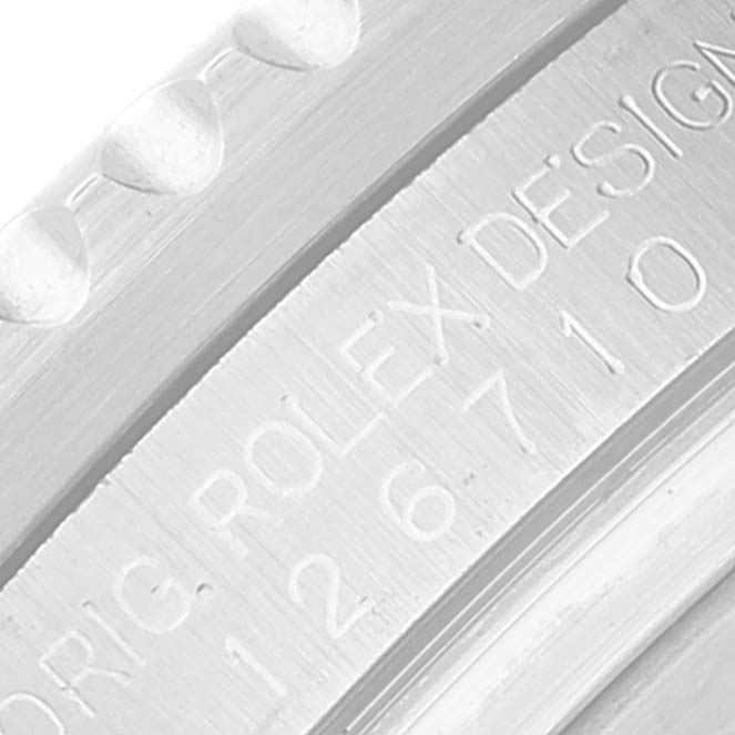 The image shows a close-up of the engraving on the side of a Rolex GMT-Master 126710 Men
s Stainless Steel Black Dial 126710 Men
s Stainless Steel Black Dial bezel.