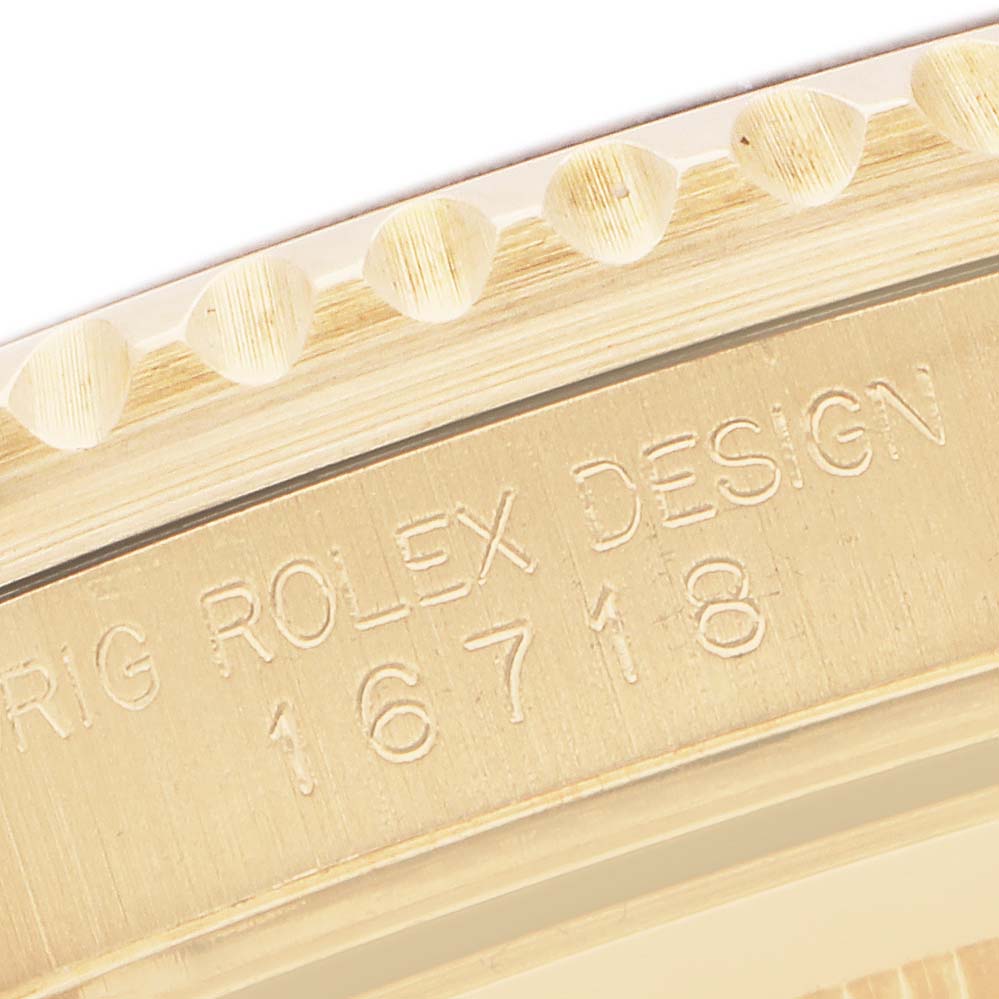 The image shows a close-up of the side engraving on a Rolex GMT-Master 16718 Men's Yellow Gold Brown Dial, displaying the model number.