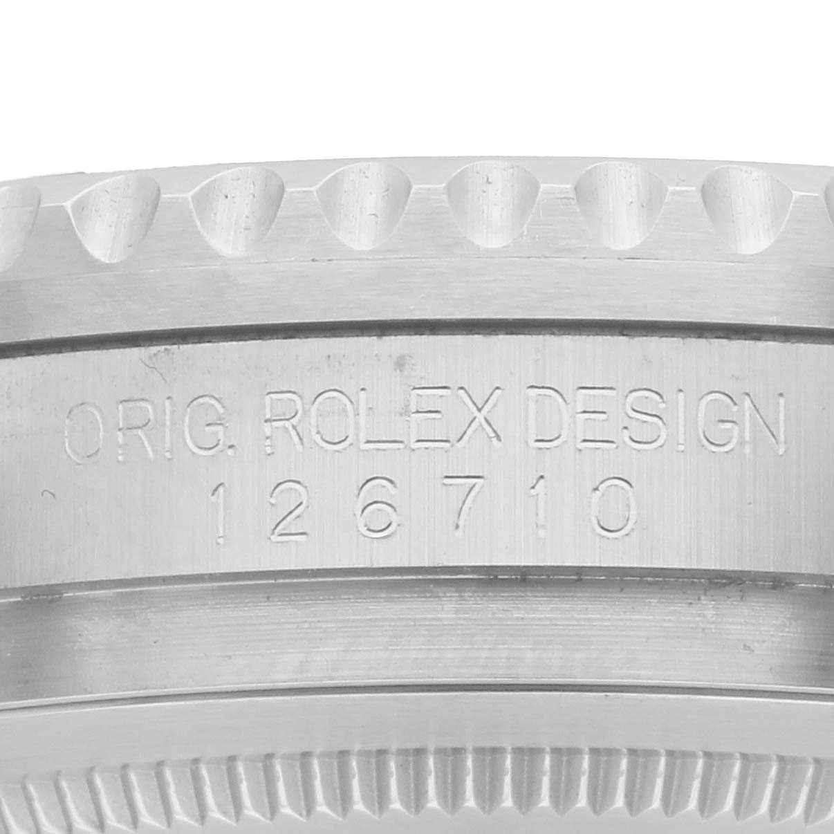 The image shows a close-up of the engraved side of a Rolex GMT-Master 126710 Men's Stainless Steel Black Dial, focusing on the case's edge with the model number.