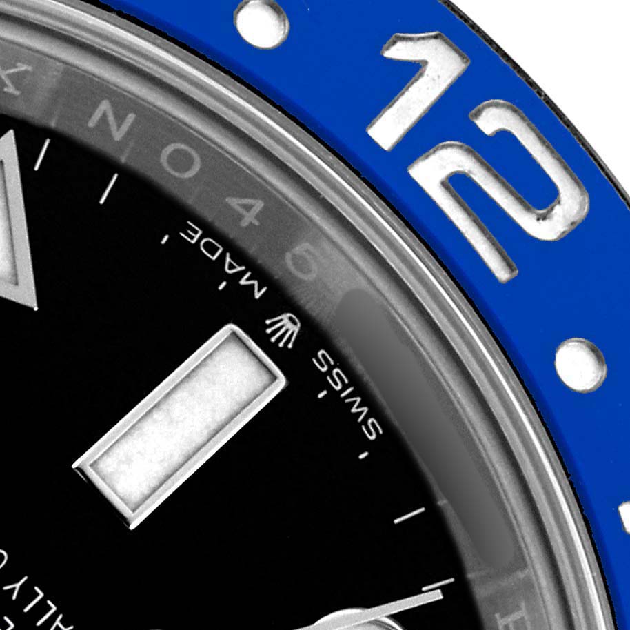 The image shows a close-up of the bezel and part of the dial of a Rolex GMT-Master 126710 Men's Stainless Steel Black Dial, highlighting the "12" on the blue bezel.