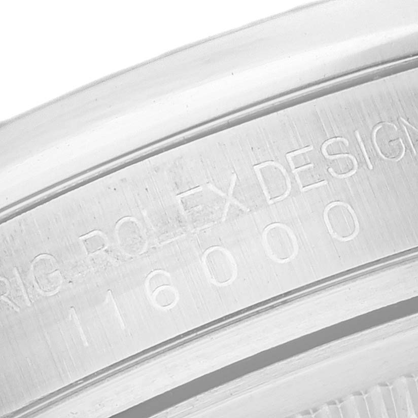 This image shows a close-up of the engraving on the case back of a Rolex Oyster Perpetual 116000 Men's Stainless Steel Silver Dial 116000 Men's Stainless Steel Silver Dial watch.