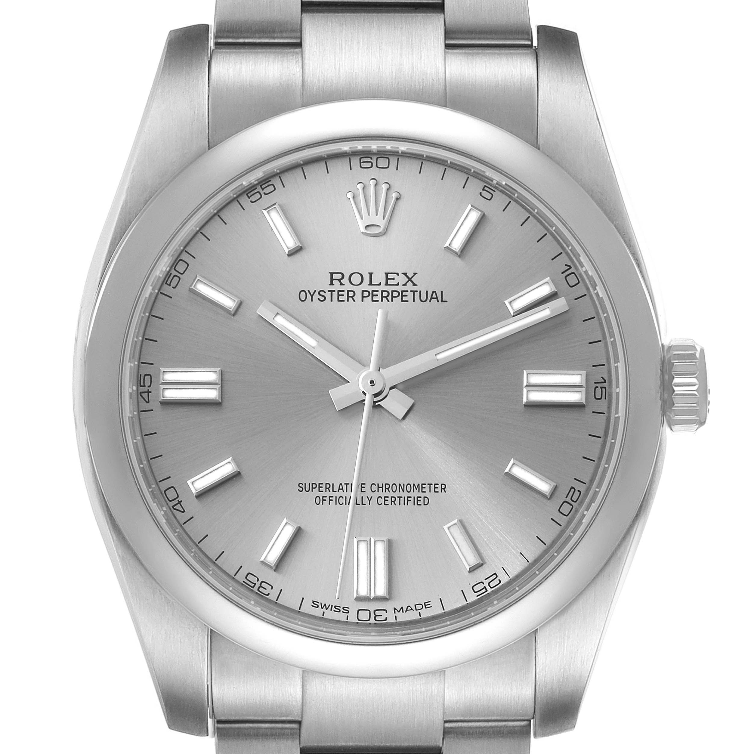 The Rolex Oyster Perpetual 116000 Men's Stainless Steel Silver Dial 116000 Men's Stainless Steel Silver Dial watch is shown from a front angle, displaying its dial, hour markers, hands, and part of the bracelet.