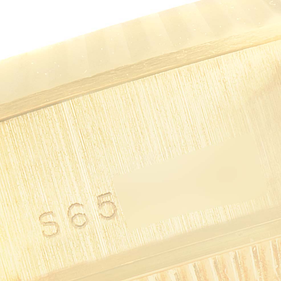 This close-up image shows a partial view of the serial number area of a Rolex President 69178 Women
s Yellow Gold Blue Dial 69178 Women
s Yellow Gold Blue Dial model watch.