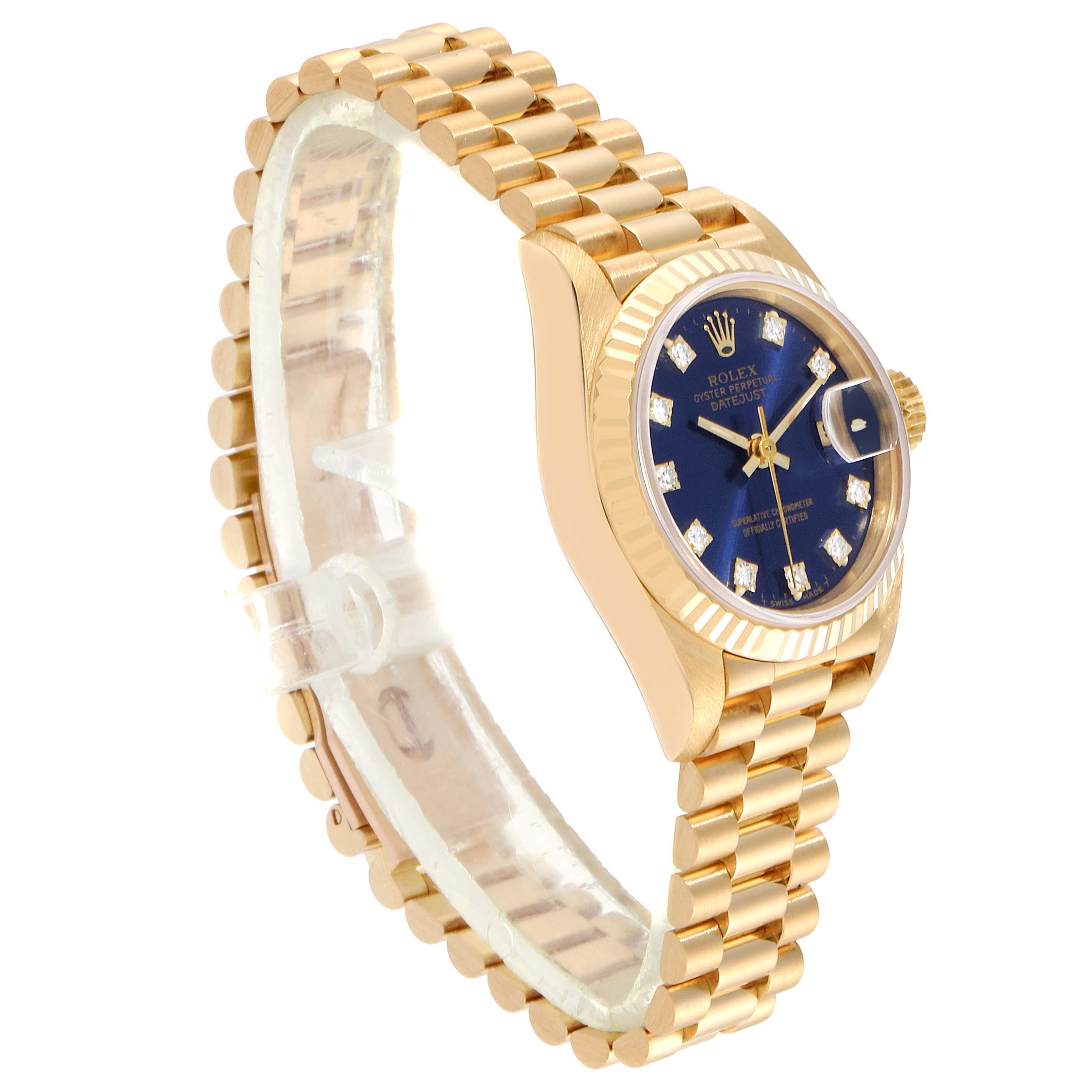 The image shows a side profile of a Rolex President 69178 Women
s Yellow Gold Blue Dial 69178 Women
s Yellow Gold Blue Dial model watch, highlighting its gold bracelet, fluted bezel, and blue dial with diamond markers.