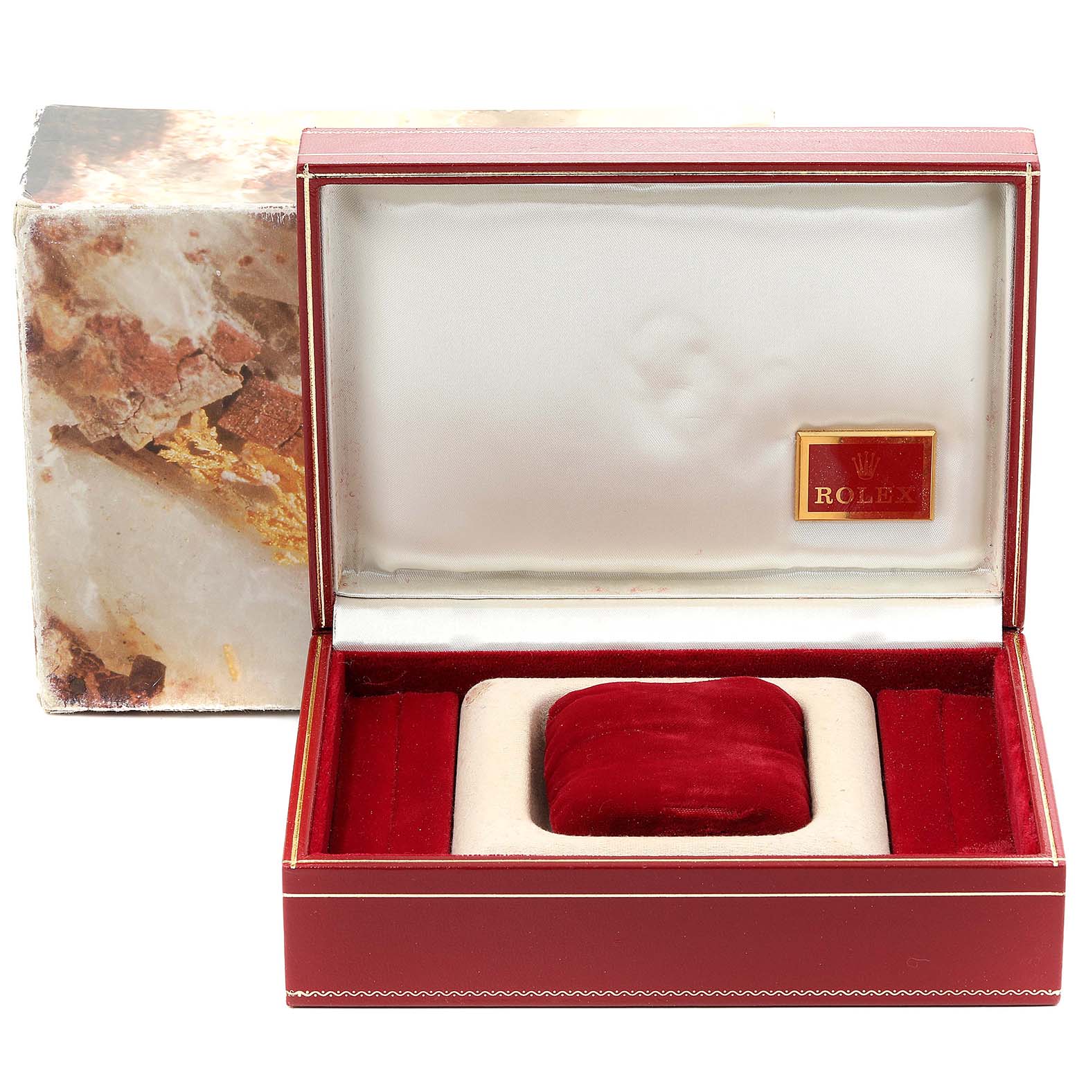 The image shows an empty red Rolex President 69139 Women's Yellow Gold Mother of Pearl Dial 69139 Women's Yellow Gold Mother of Pearl Dial watch box, with an open lid displaying the interior velvet cushion and emblem.